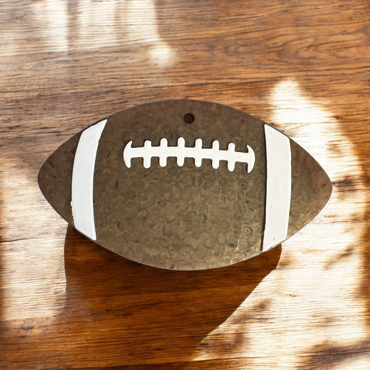 Football Freshie air freshener from Bug & Bean Freshies hanging with football design and vibrant colors.