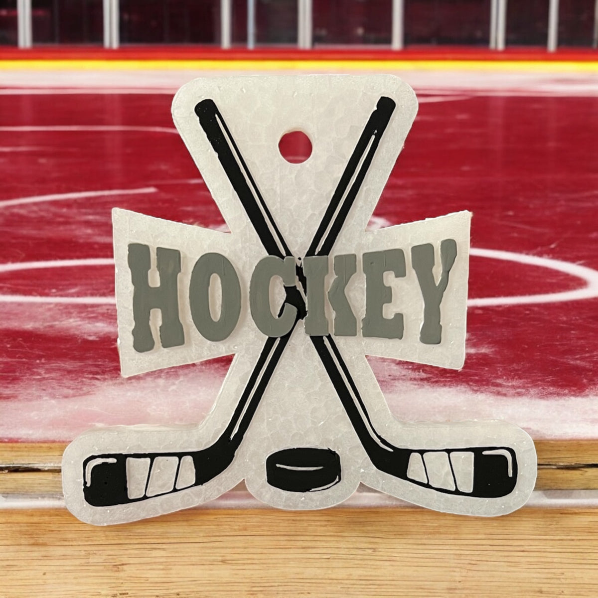Hockey Freshie by Bug & Bean Freshies hanging with a hockey-themed design and fresh scent, used to keep sports gear smelling fresh