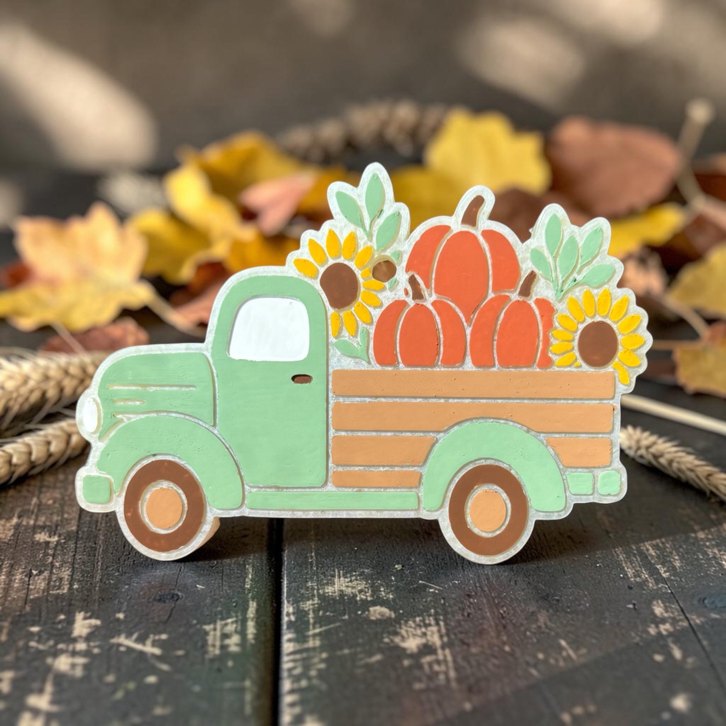 Fall Truck Freshie by Bug & Bean Freshies hanging on a vehicle mirror, featuring autumn-themed scents and a decorative truck shape.