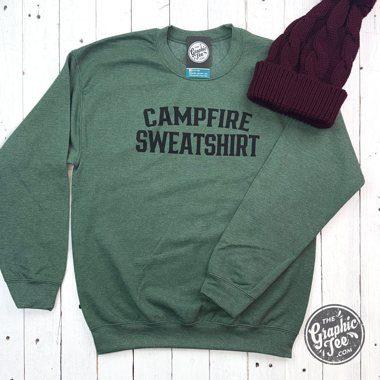 Heather dark green crewneck sweatshirt with campfire graphic, from The Graphic Tee, perfect for casual wear and outdoor adventures.