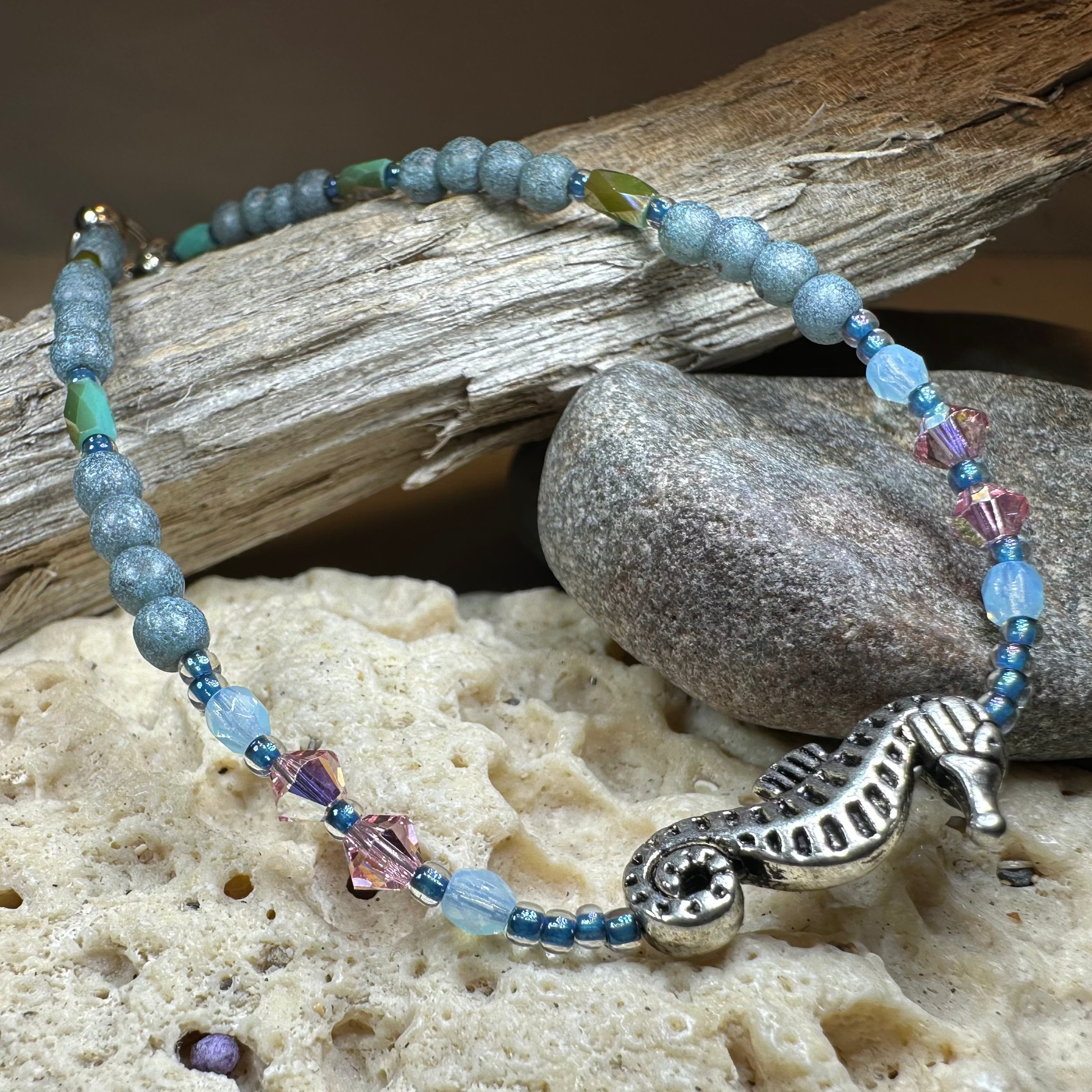 Beachy Seahorse ankle bracelet by Celtic Crystal Design Jewelry featuring green and pink sea-themed charms on a delicate bracelet.