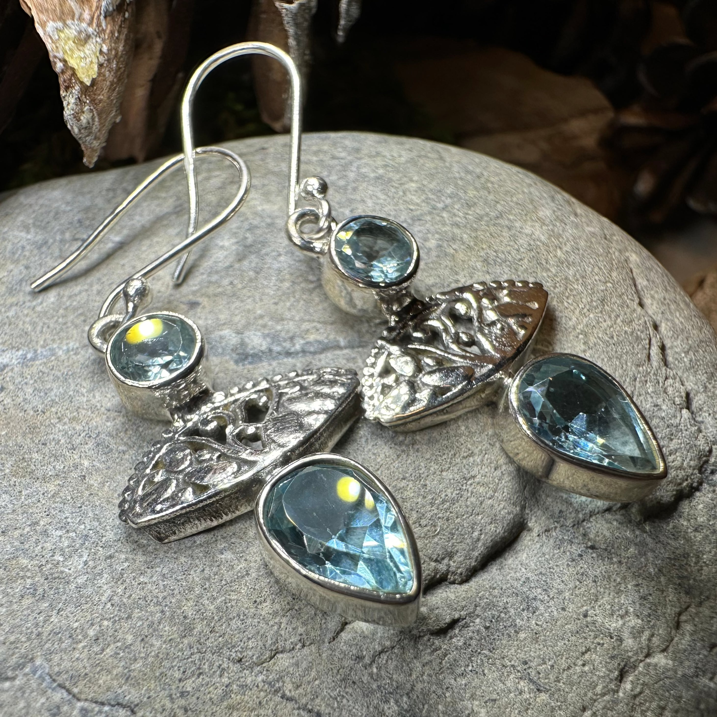 Celtic Morning Blue Topaz Dangle Earrings from Celtic Crystal Design Jewelry with intricate silver Celtic motifs and vibrant blue topaz.