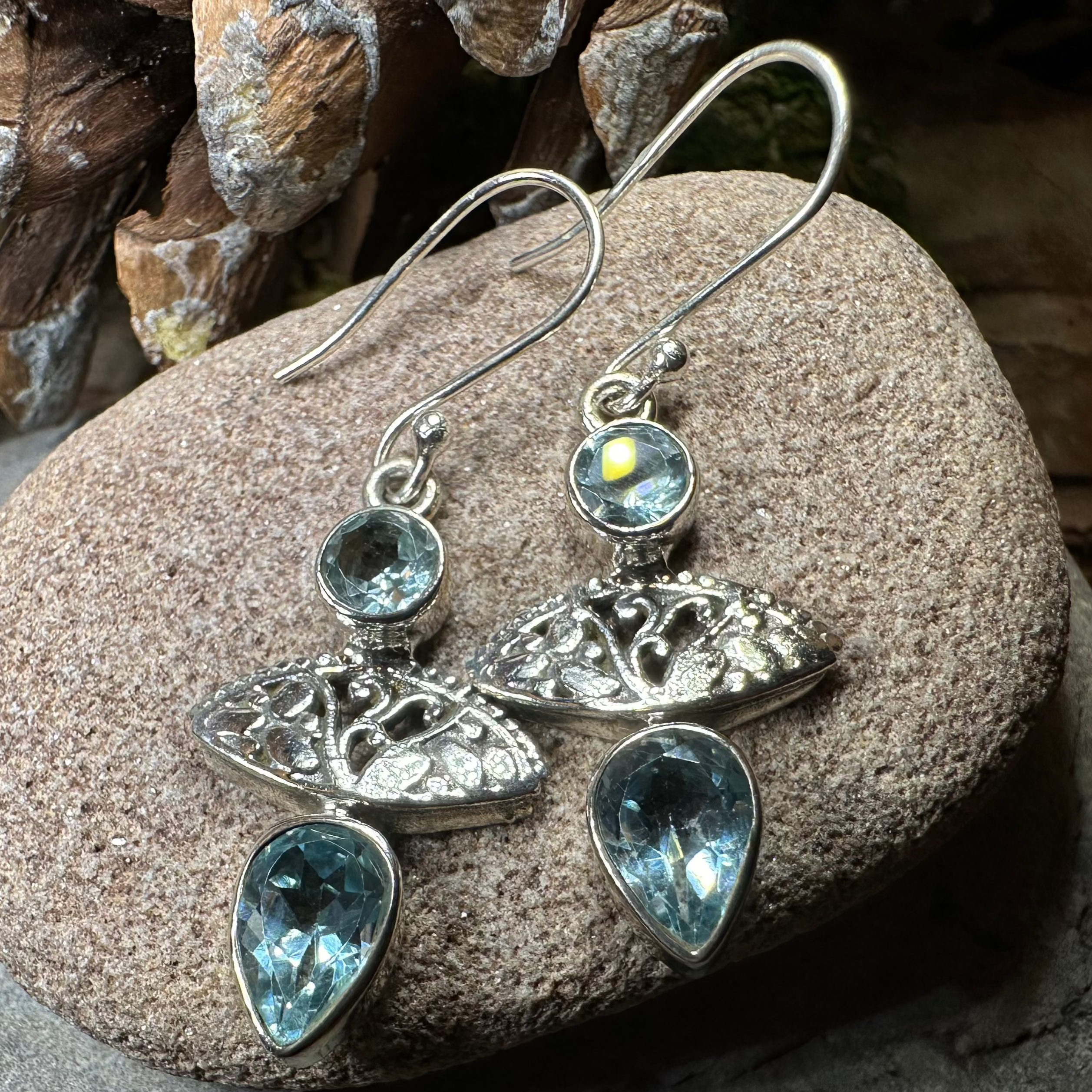 Celtic Morning Blue Topaz Dangle Earrings by Celtic Crystal Design Jewelry featuring sparkling blue topaz stones and intricate Celtic detailing.