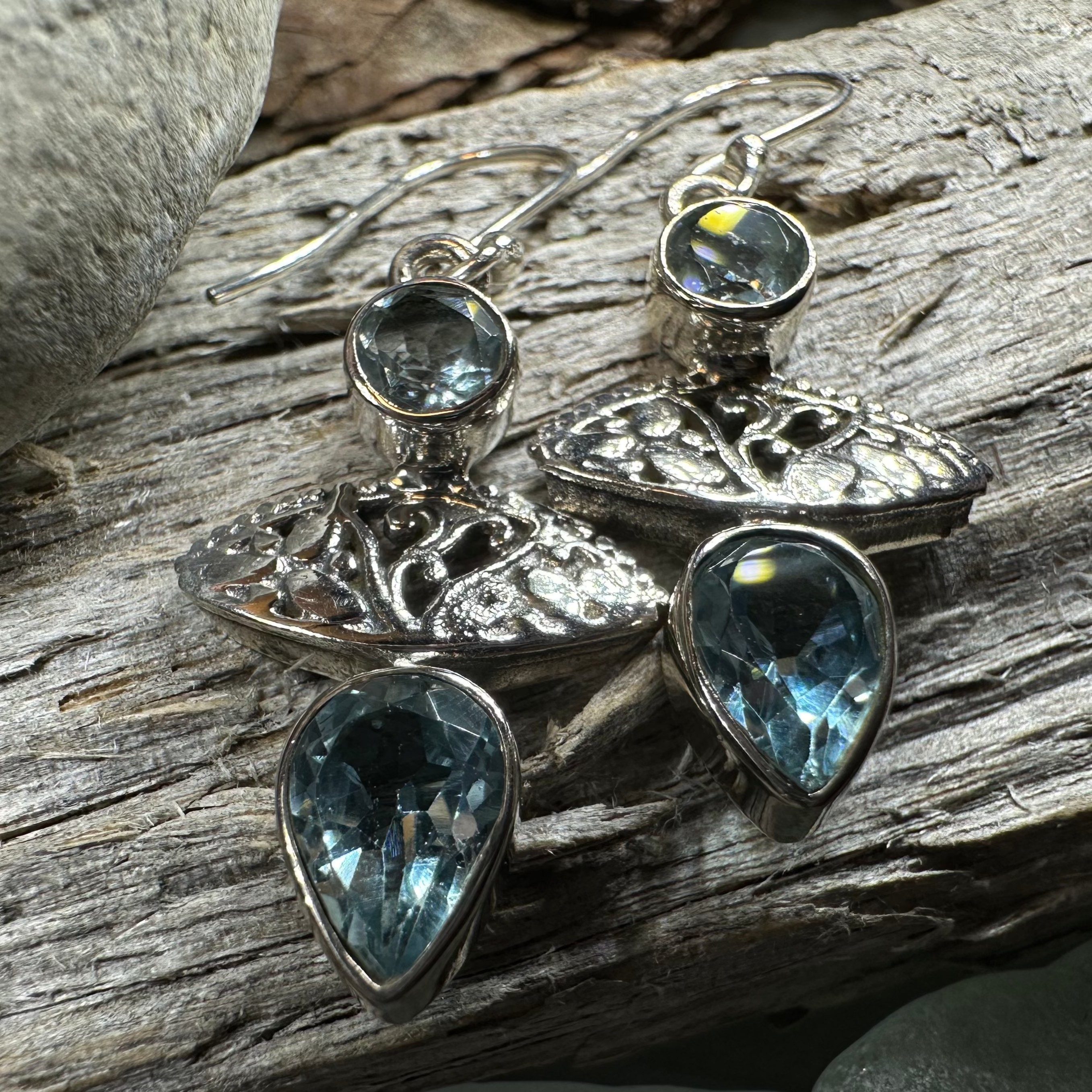 Celtic Morning Blue Topaz Dangle Earrings featuring intricate Celtic design and sparkling blue topaz gemstones.