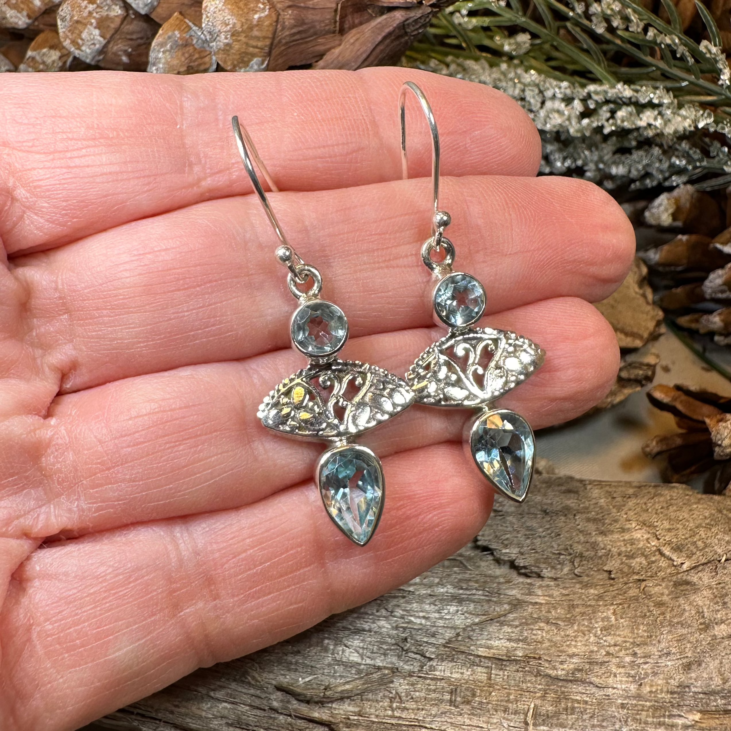 Celtic Morning Blue Topaz Dangle Earrings by Celtic Crystal Design Jewelry featuring sparkling blue topaz gemstones and intricate Celtic patterns.