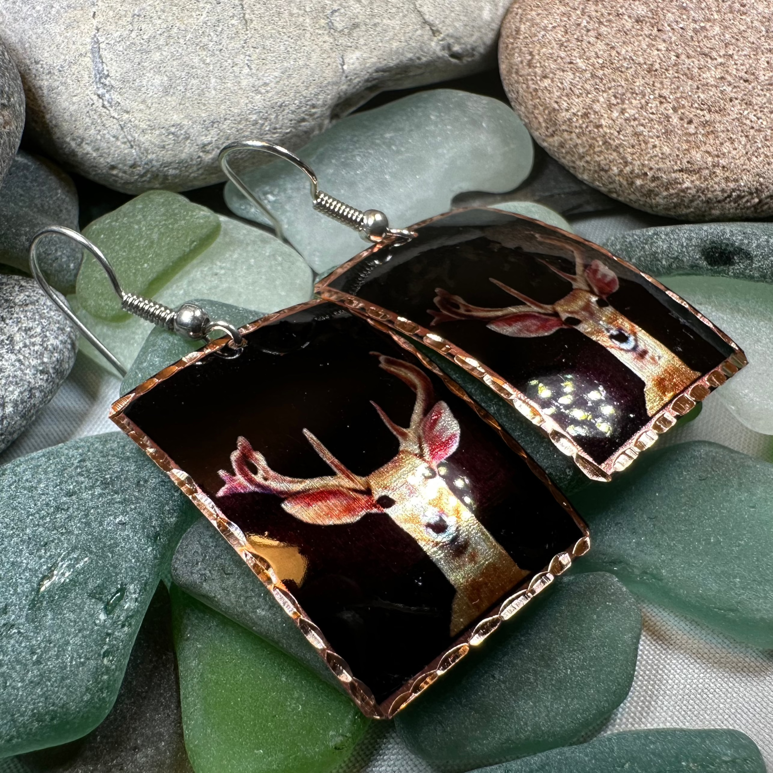 Highland Stag copper dangle earrings by Celtic Crystal Design Jewelry featuring intricate stag and Celtic patterns.