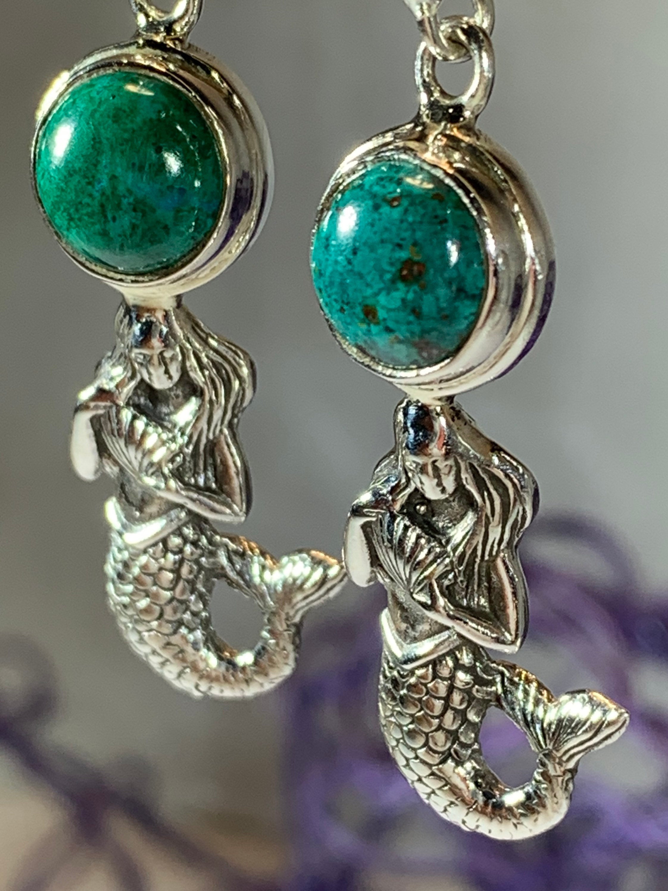 Celtic Crystal Design Jewelry purple charoite Ariel Mermaid dangle earrings featuring intricate mermaid design and silver hooks.