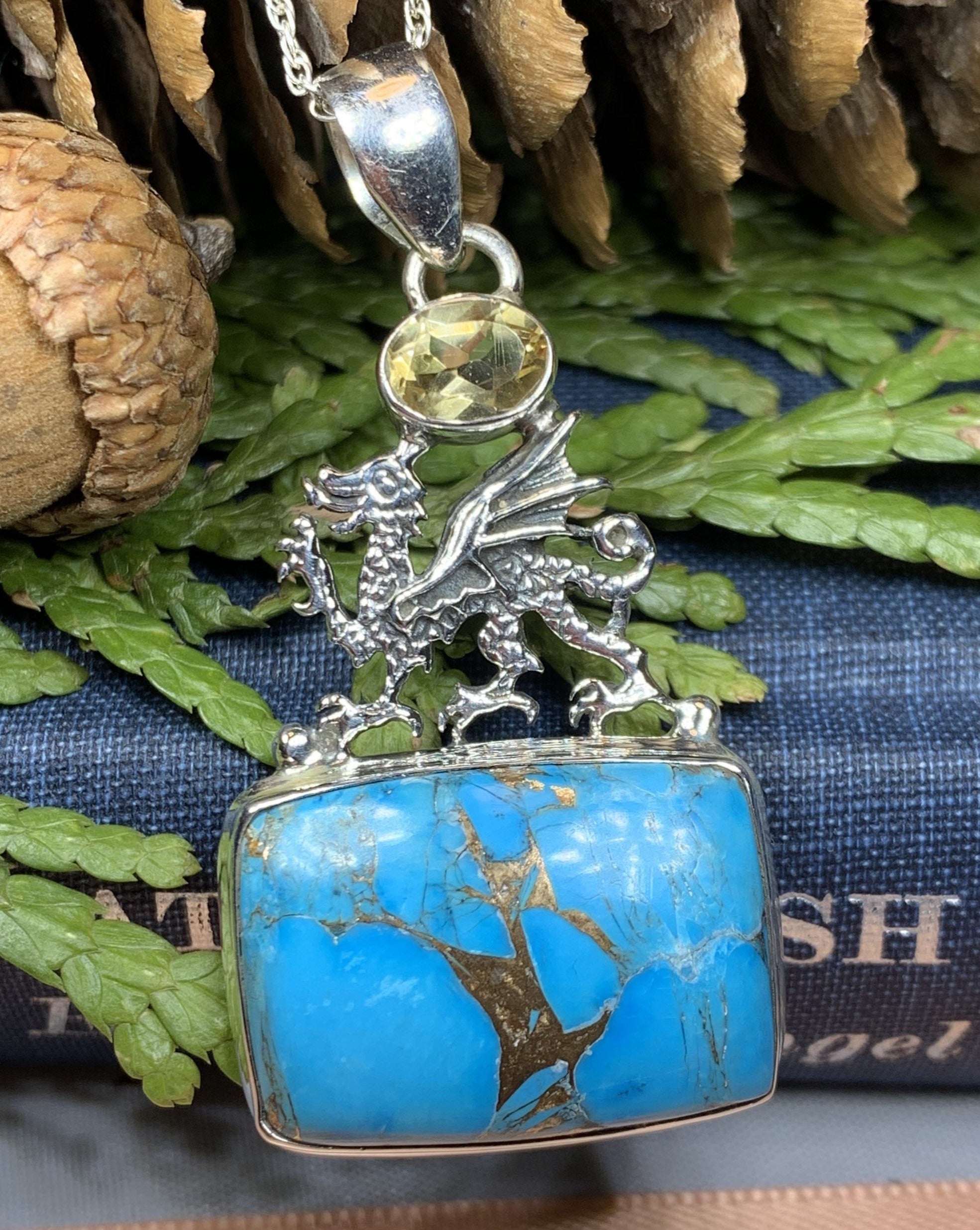 Celtic Crystal Design Jewelry pendant featuring a dragon motif with turquoise and blue citrine stones on a necklace.