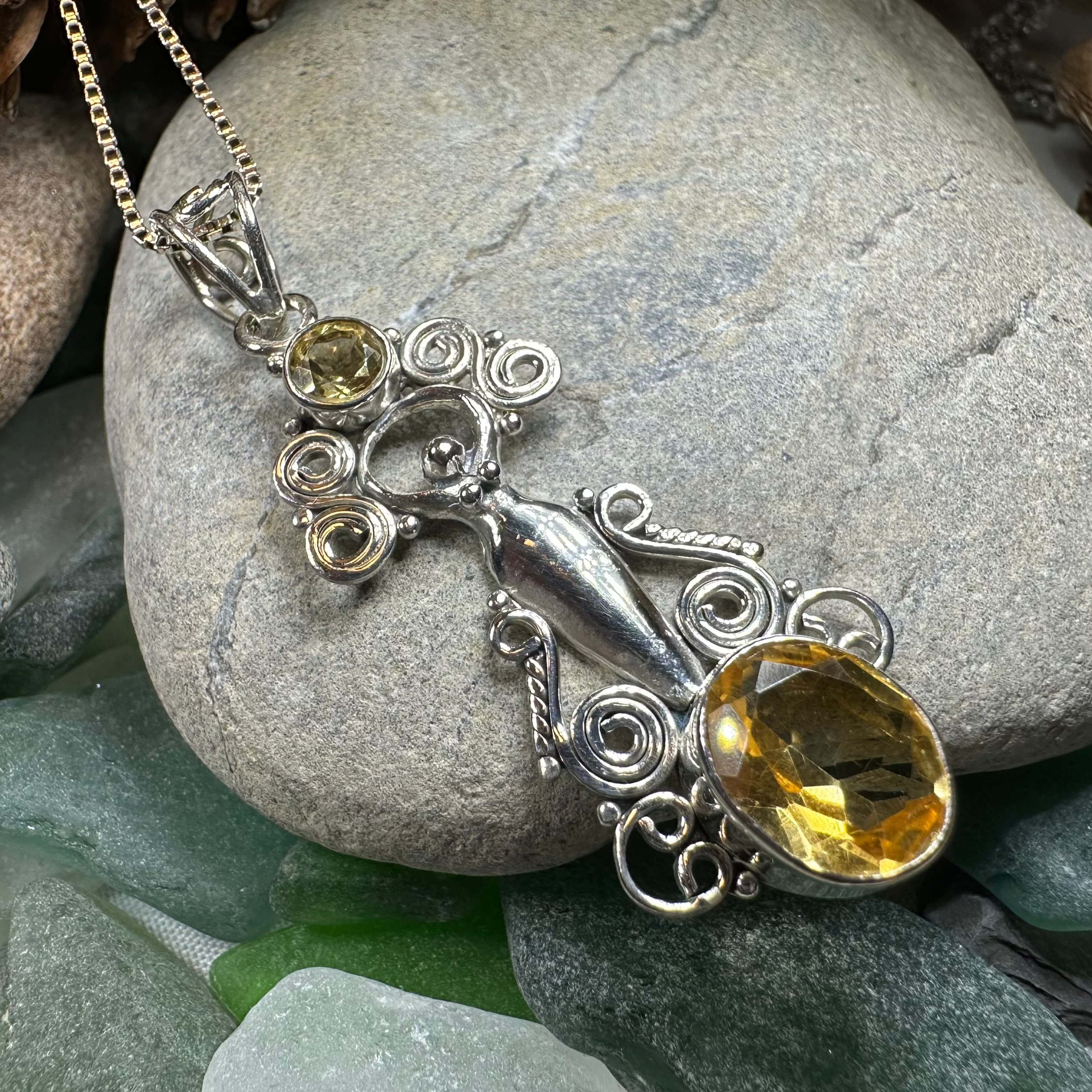 Celtic Crystal Design Jewelry Rising Goddess pendant necklace with oval citrine gemstone, intricate Celtic knot details.