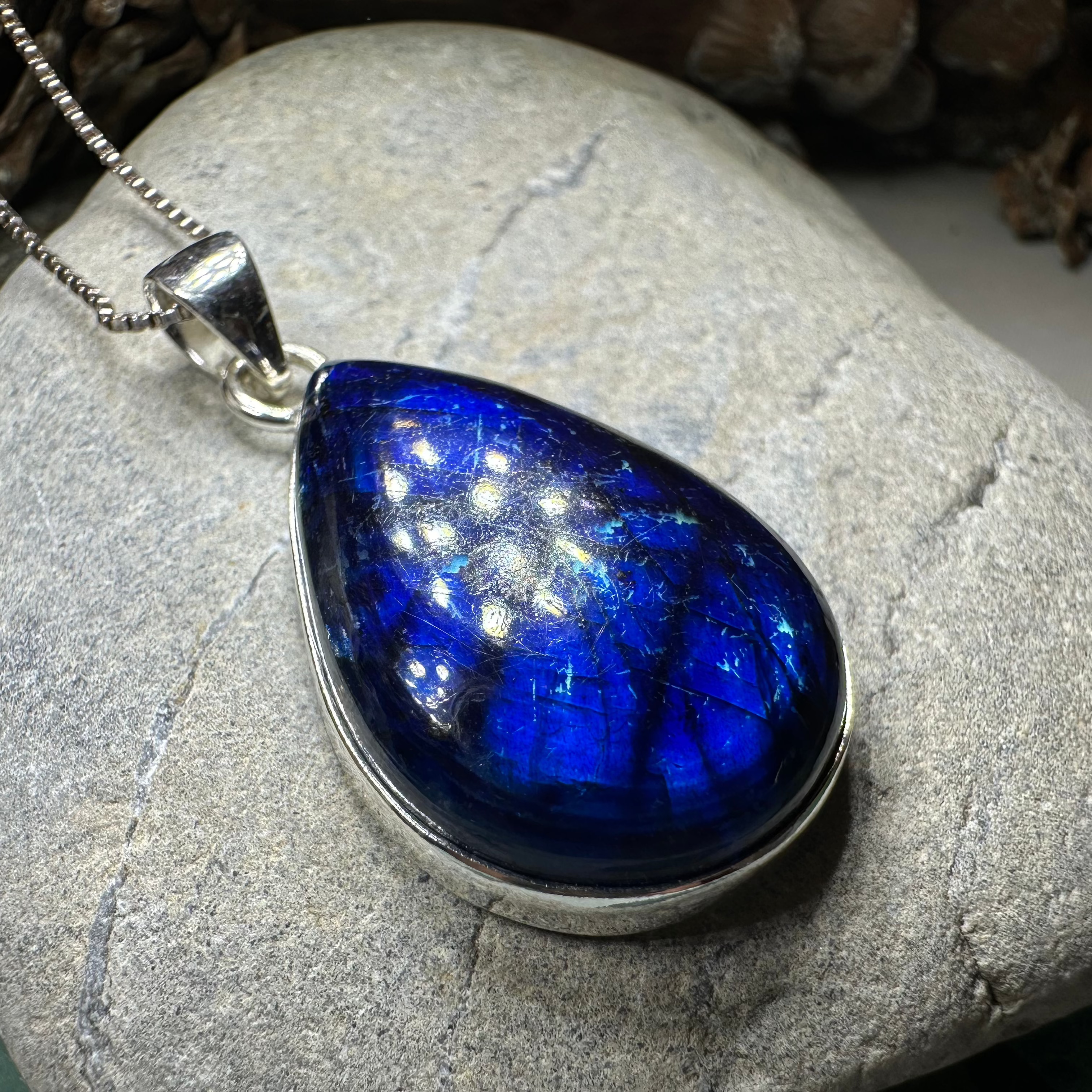 Celtic Crystal Design Jewelry Galaxy Blue Labradorite pendant necklace with large, polished labradorite stone and intricate Celtic detailing