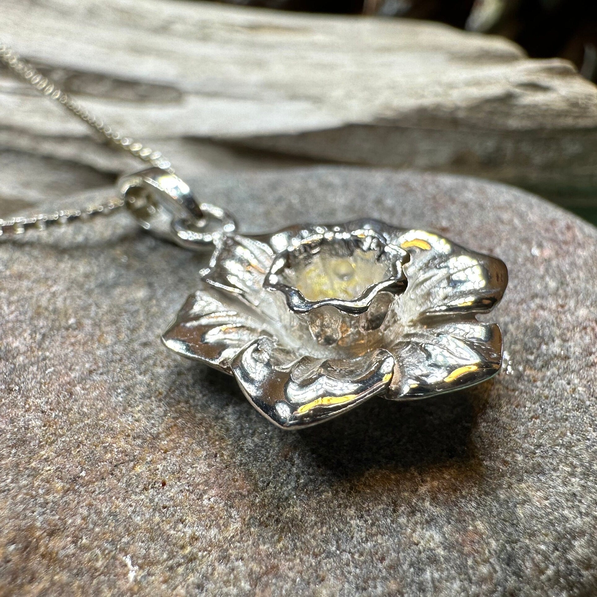 Celtic Crystal Design Jewelry Welsh Daffodil pendant necklace featuring a delicate floral charm on a silver chain.