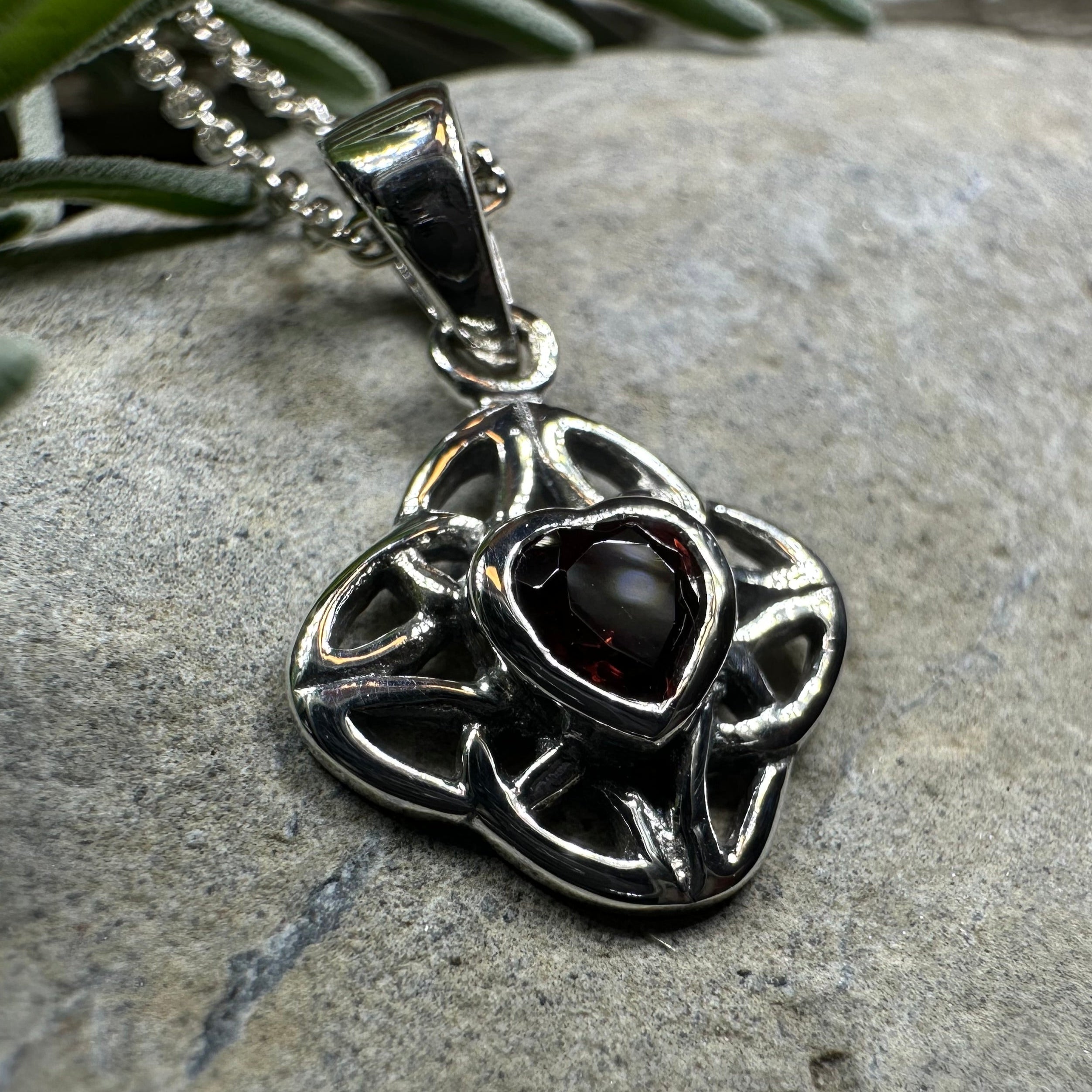 Amethyst Celtic Knot pendant necklace by Celtic Crystal Design Jewelry featuring intricate knot design and a purple gemstone.