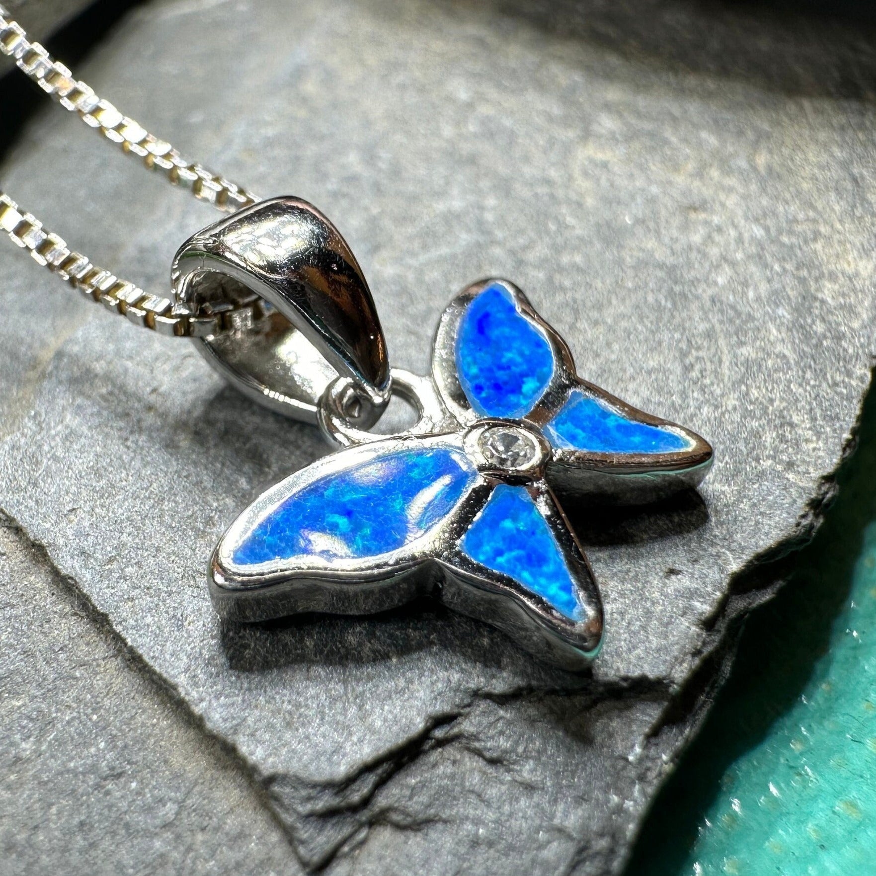 Petite pink opal butterfly pendant necklace by Celtic Crystal Design Jewelry, showcasing a delicate butterfly-shaped gemstone pendant.