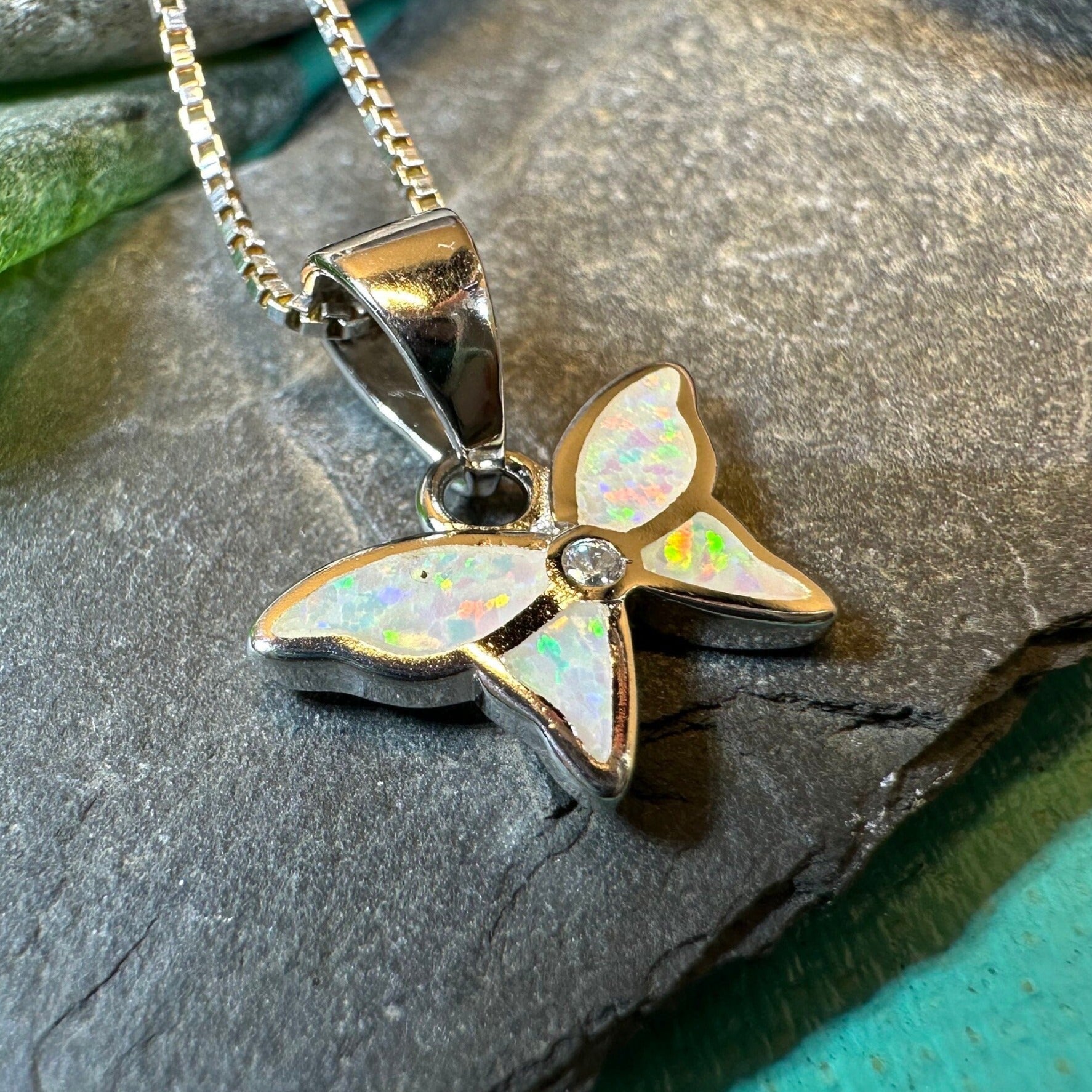 Petite opal butterfly pendant necklace by Celtic Crystal Design Jewelry featuring a pink opal gemstone and delicate butterfly charm.