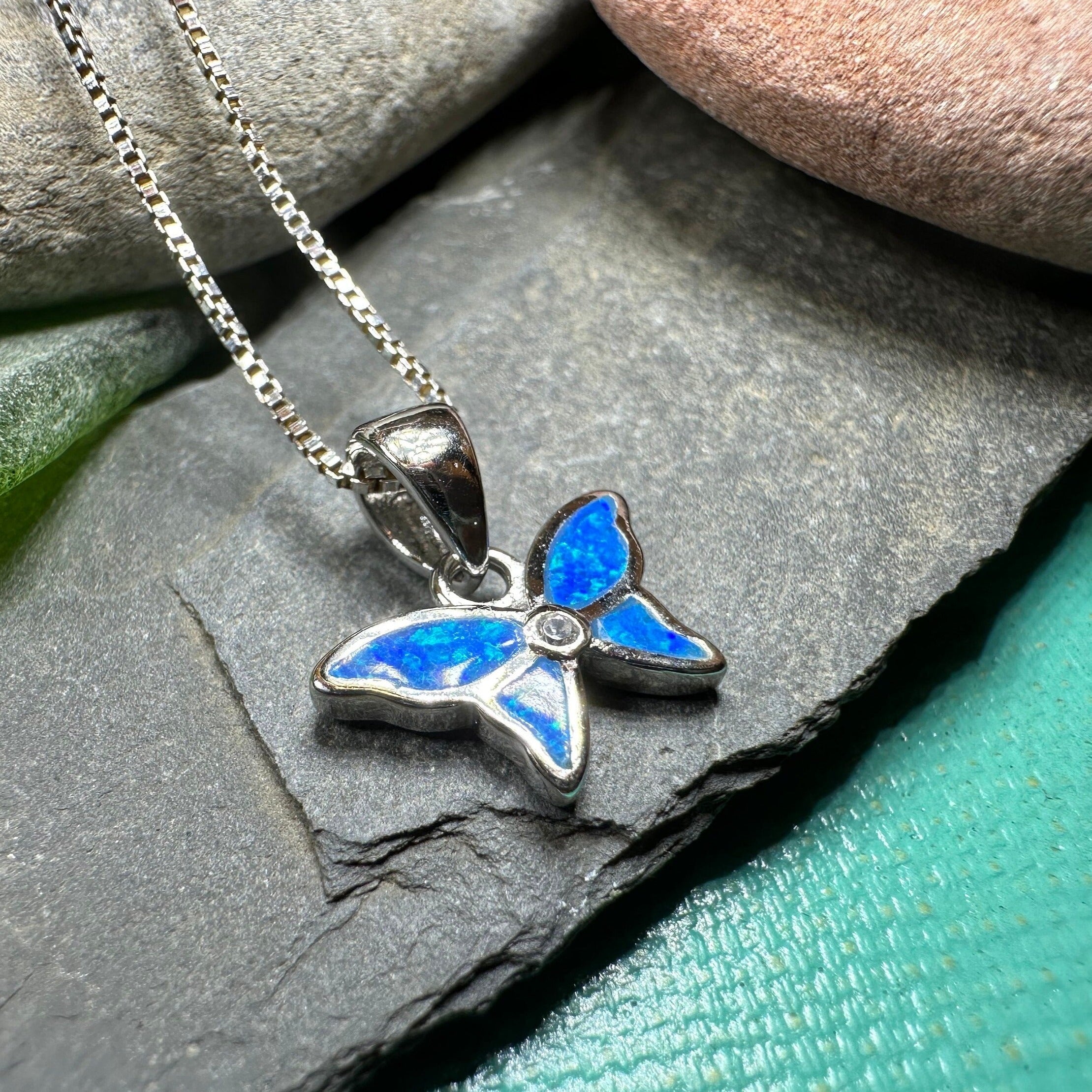 Petite pink opal butterfly pendant necklace by Celtic Crystal Design Jewelry, featuring a delicate and colorful gemstone charm.