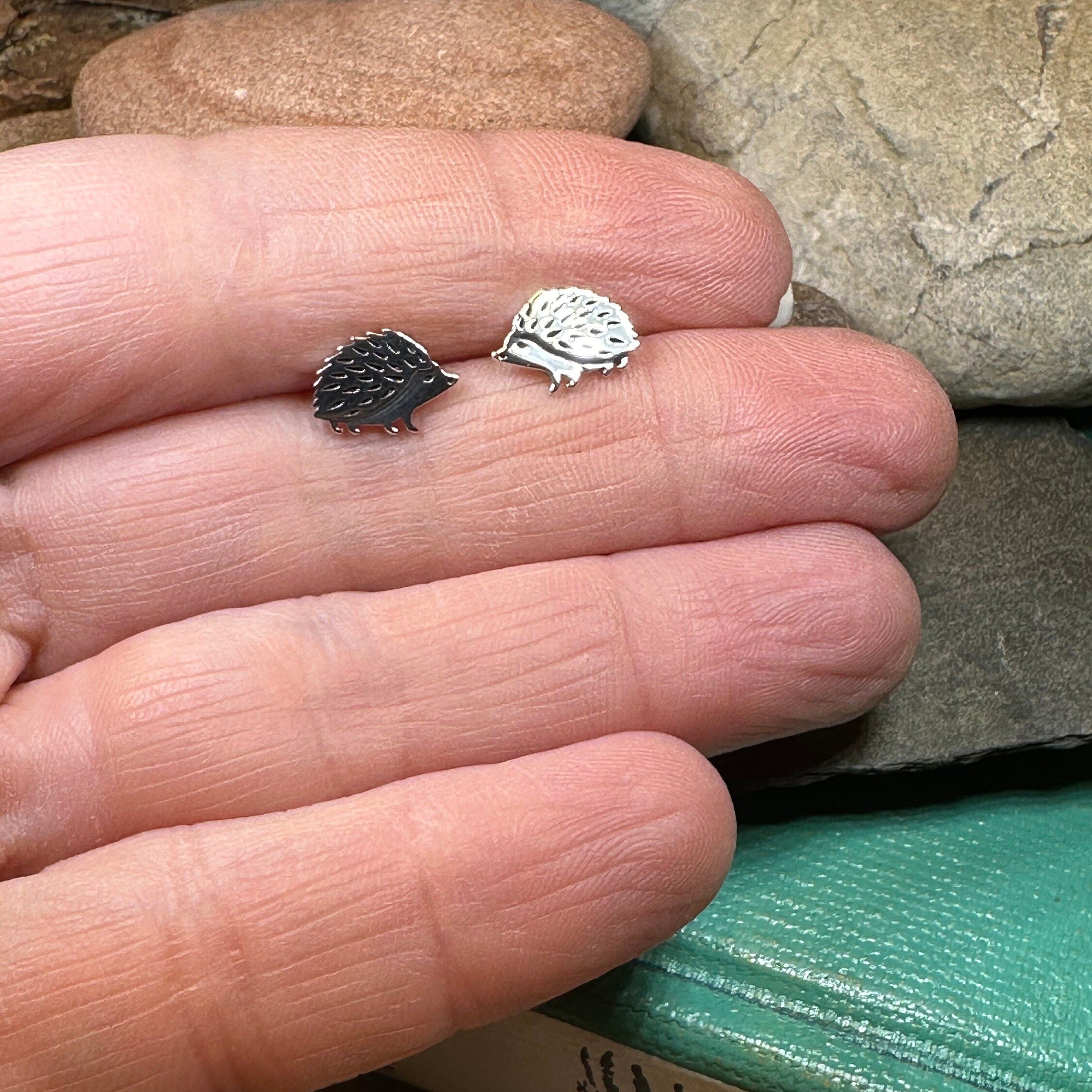 Celtic Crystal Design Jewelry hedgehog post earrings featuring detailed silver animal motifs on a white background.