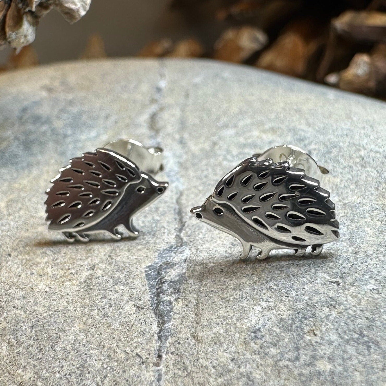 Celtic Crystal Design Jewelry hedgehog post earrings featuring detailed silver-tone animal motifs on a clean background.