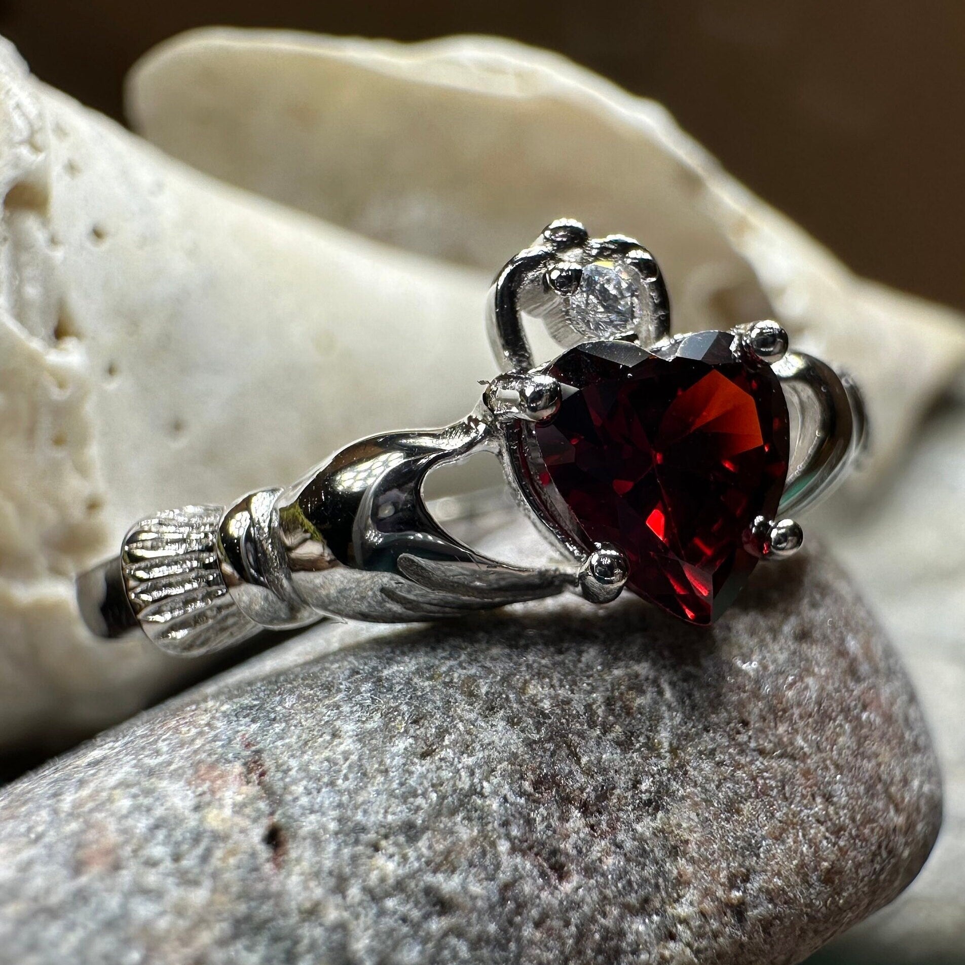Garnet Claddagh ring by Celtic Crystal Design Jewelry featuring a heart and crown design with red garnet gemstone.