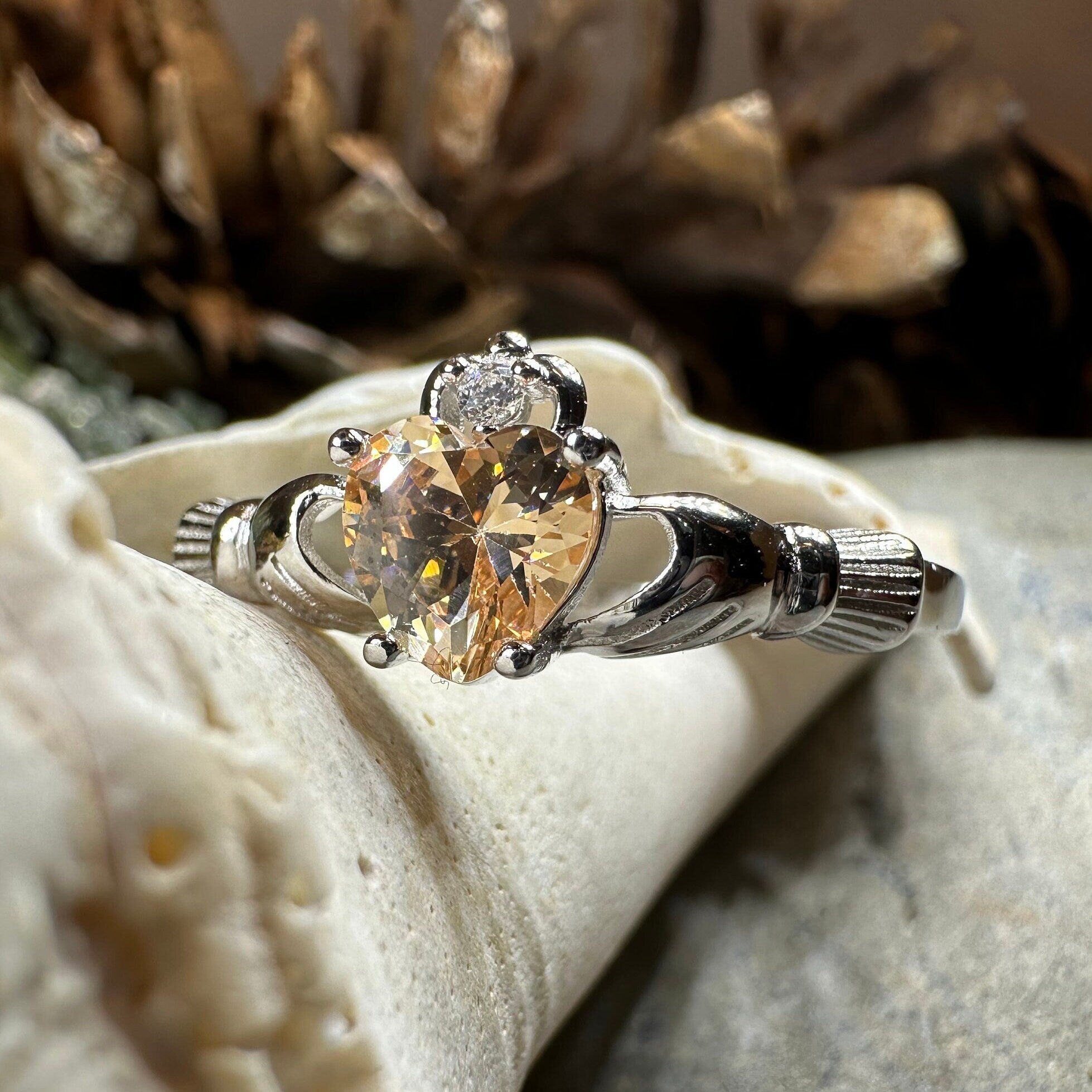 Celtic Crystal Design Jewelry Champagne Toast Claddagh Ring featuring intricate Celtic patterns and a champagne-colored crystal accent.
