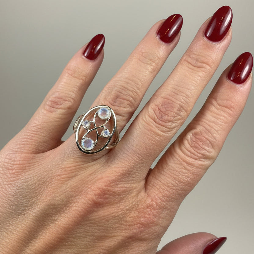Celtic Crystal Design Jewelry moonstone infinity ring showcasing a polished moonstone gemstone and intricate Celtic pattern.