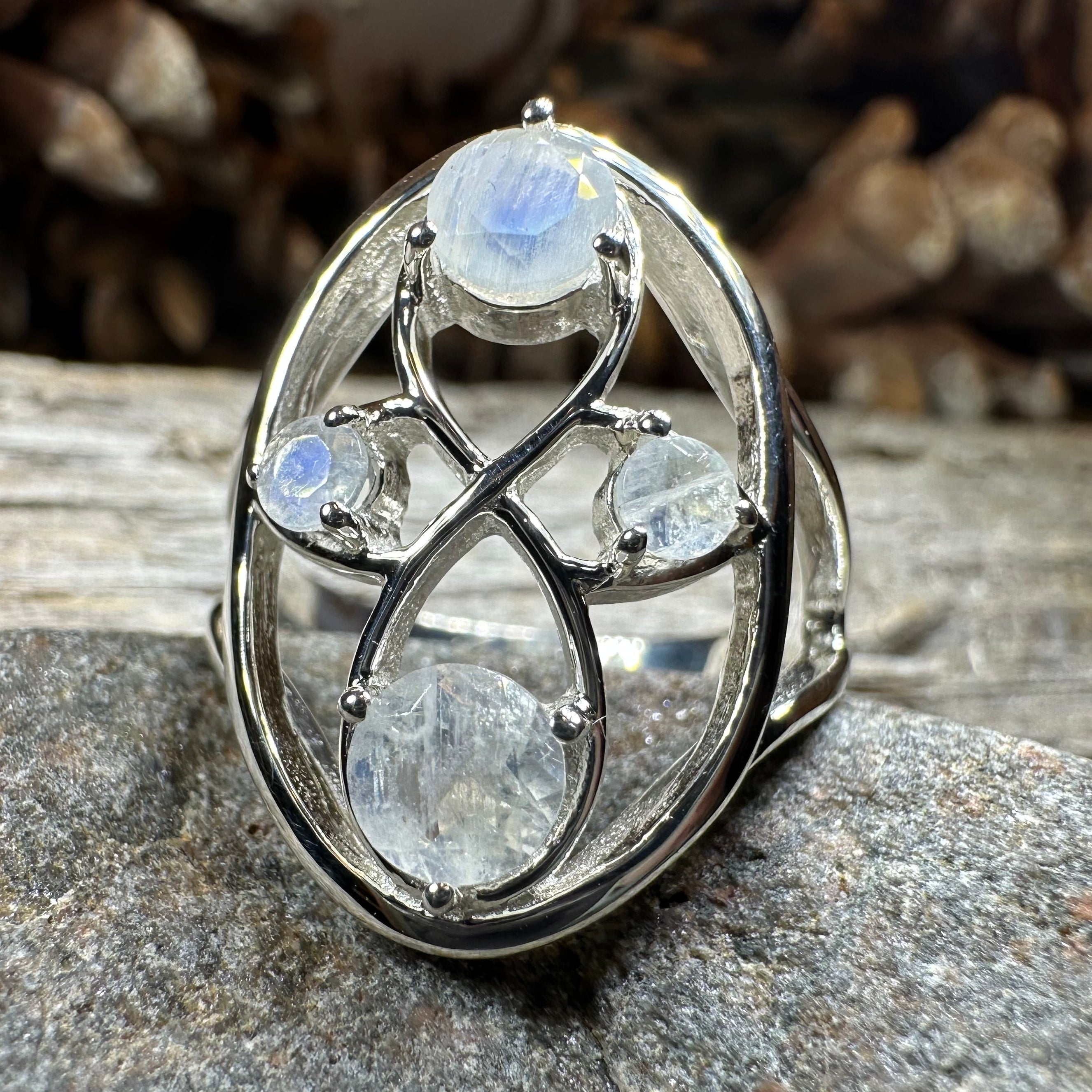 Celtic Crystal Design Jewelry moonstone infinity ring with intricate Celtic pattern and polished moonstone gemstone.