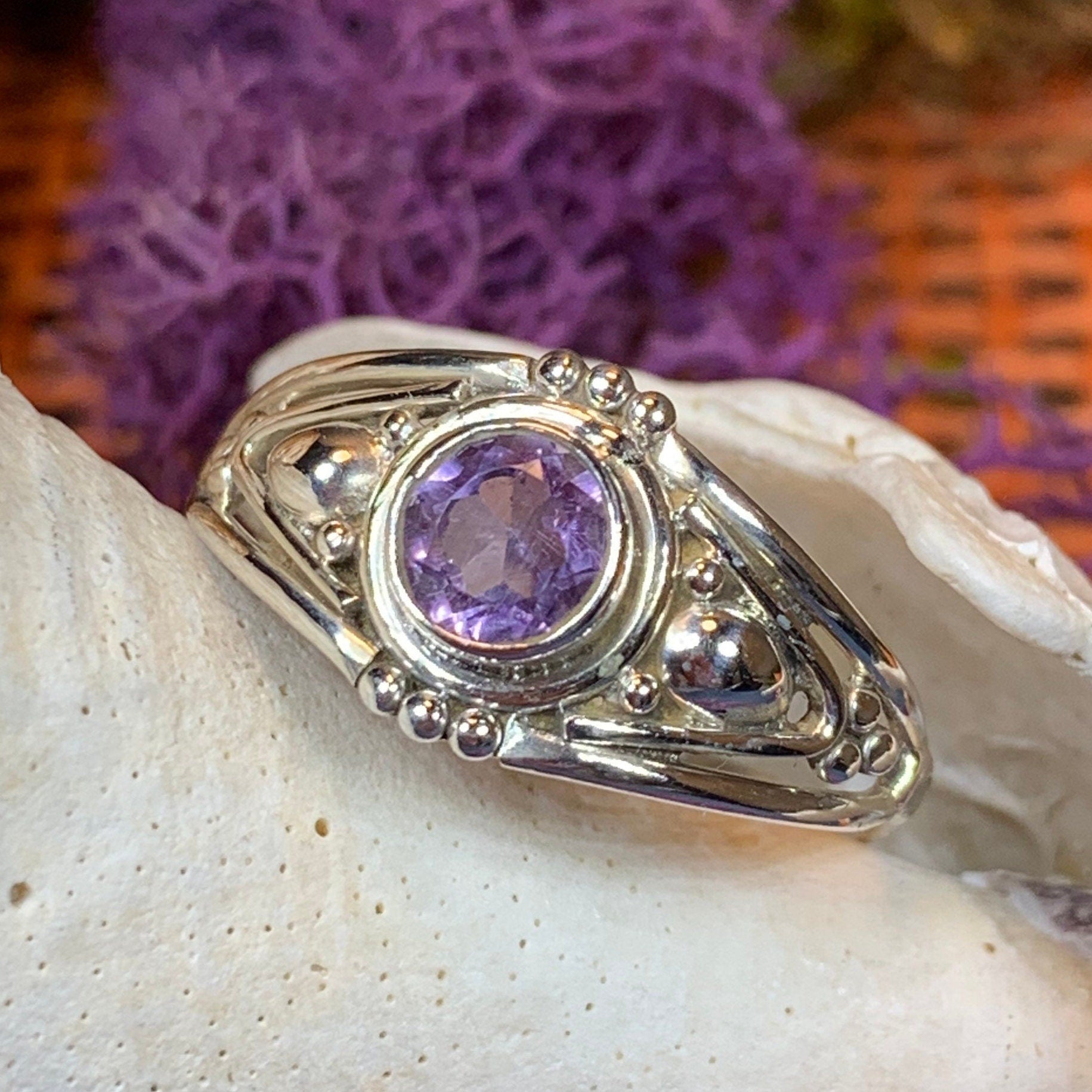 Klarina Celtic Ring by Celtic Crystal Design Jewelry featuring a silver band with intricate Celtic knot patterns and an amethyst gemstone.