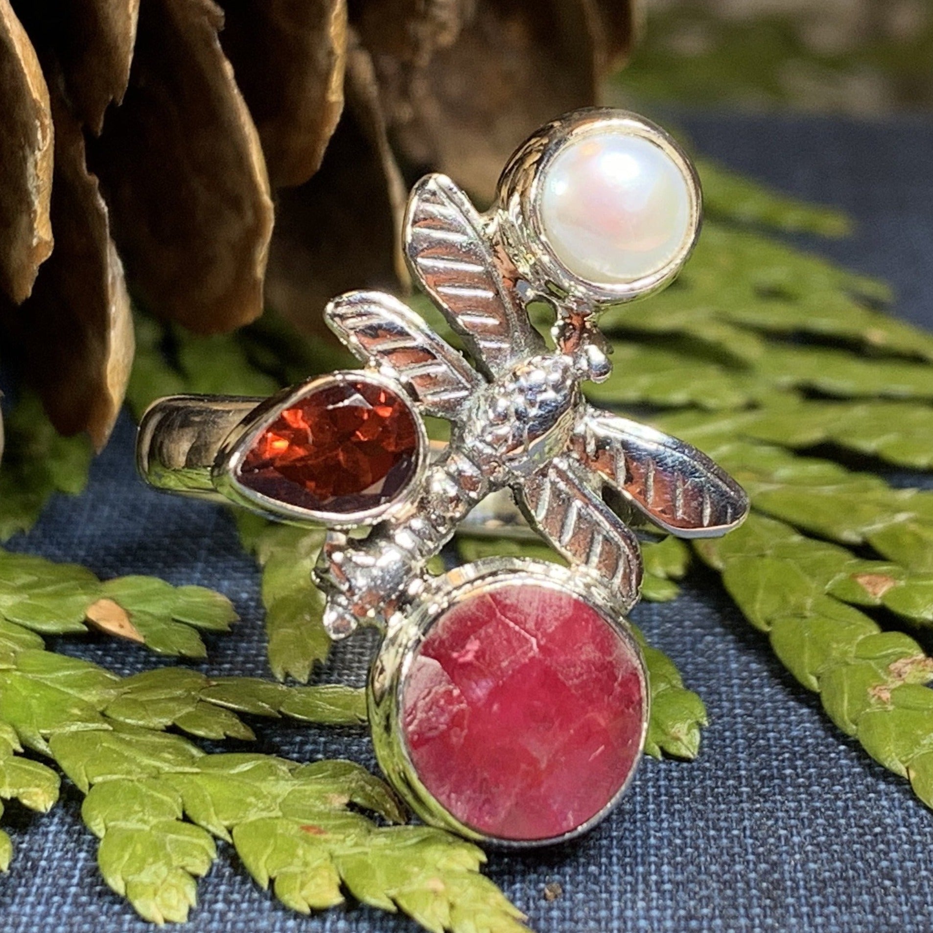 Celtic Crystal Design Jewelry dragonfly ring featuring ruby-colored accents and intricate Celtic patterns, crafted in silver.