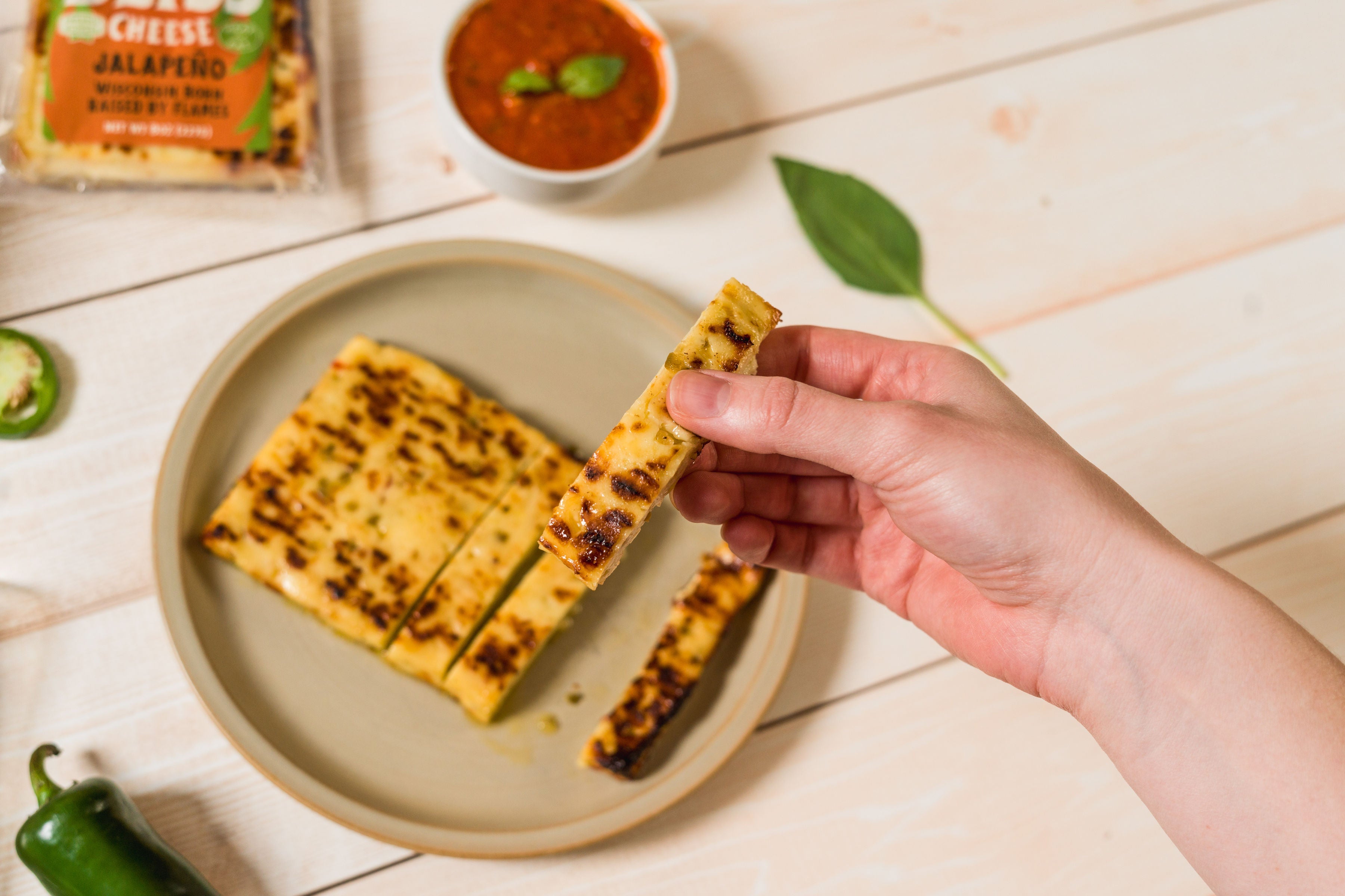 Golden baked jalapeño cheese snack from Cheese Brothers, Inc., featuring melted cheese and spicy jalapeño slices.