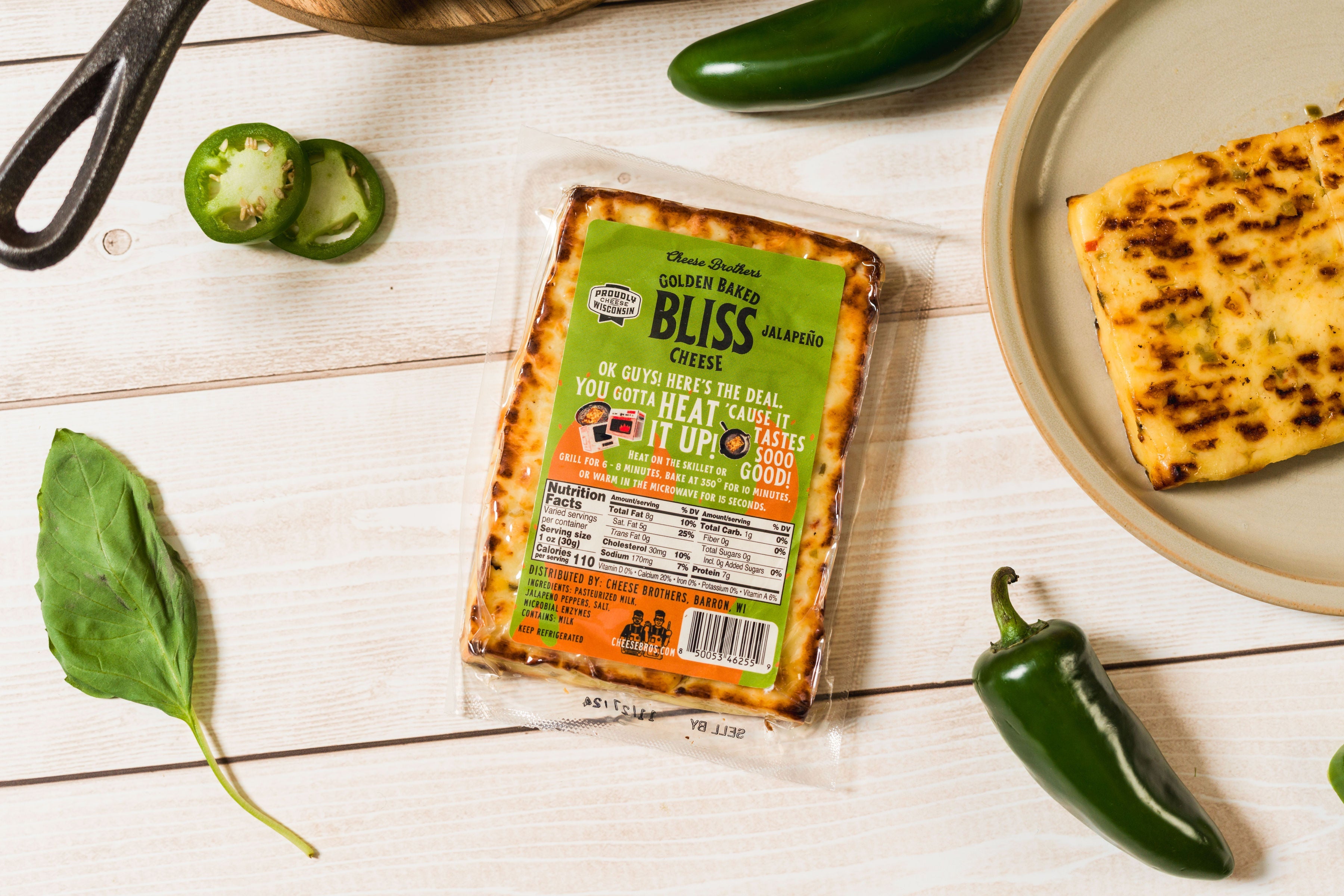 Golden baked cheese snack with jalapeño peppers from Cheese Brothers, Inc., showcasing a crispy, cheesy treat with spicy jalapeño slices.