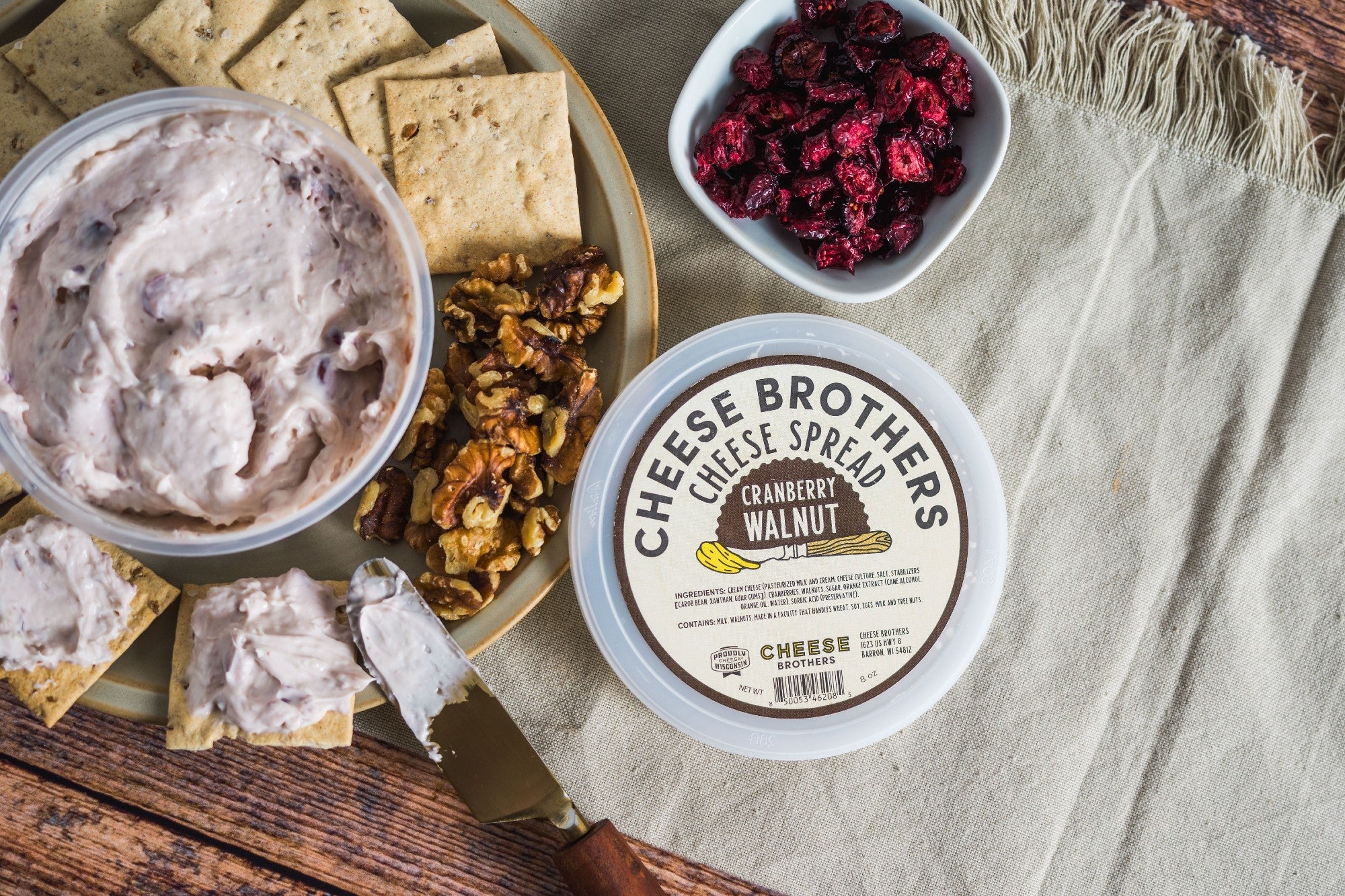 Creamy cranberry walnut cheese spread by Cheese Brothers, Inc., featuring a rich texture with cranberries and walnuts.
