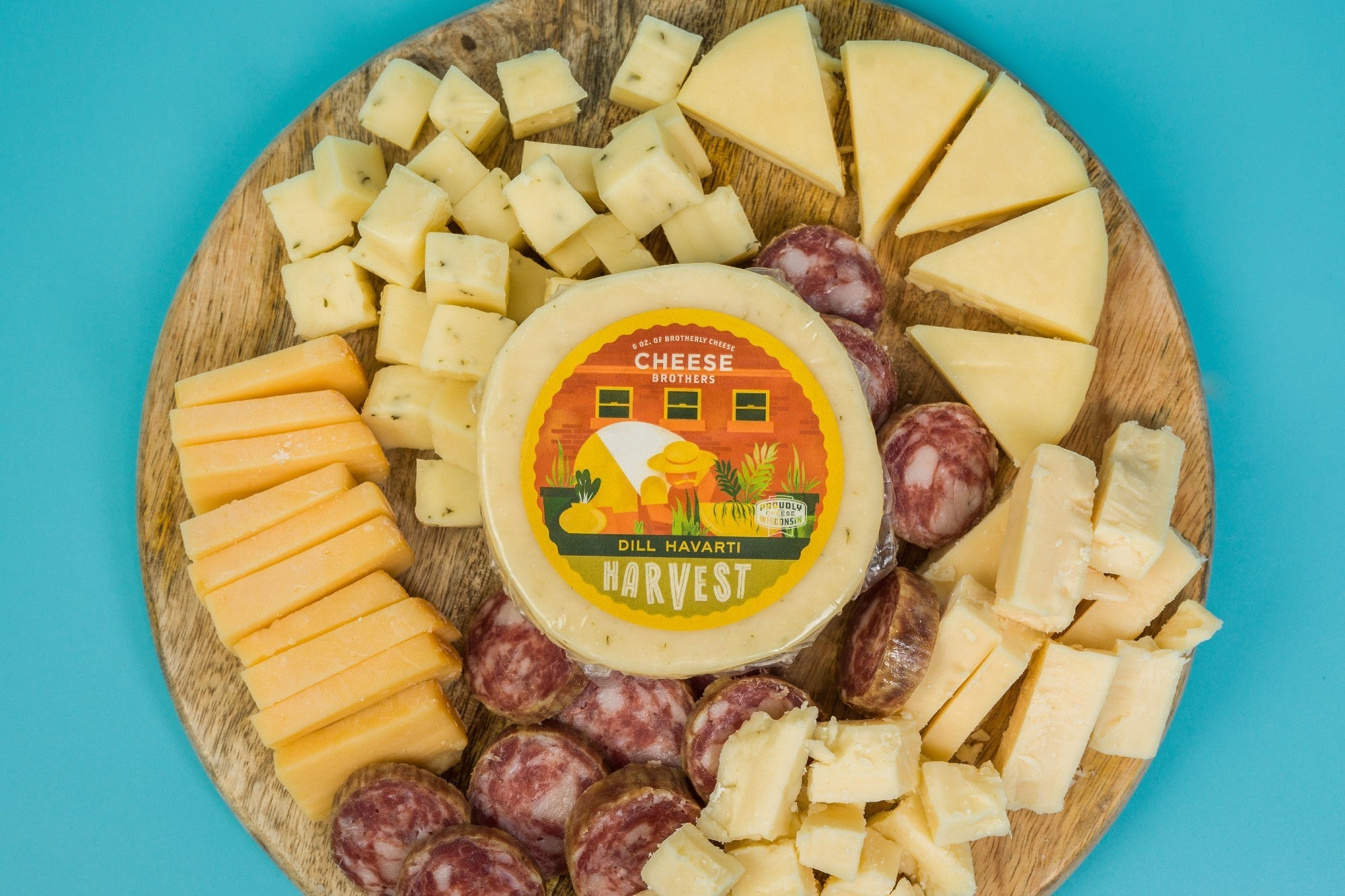 Deluxe Charcuterie Pack from Cheese Brothers, Inc. featuring assorted cured meats, cheeses, nuts, and accompaniments on a wooden board.