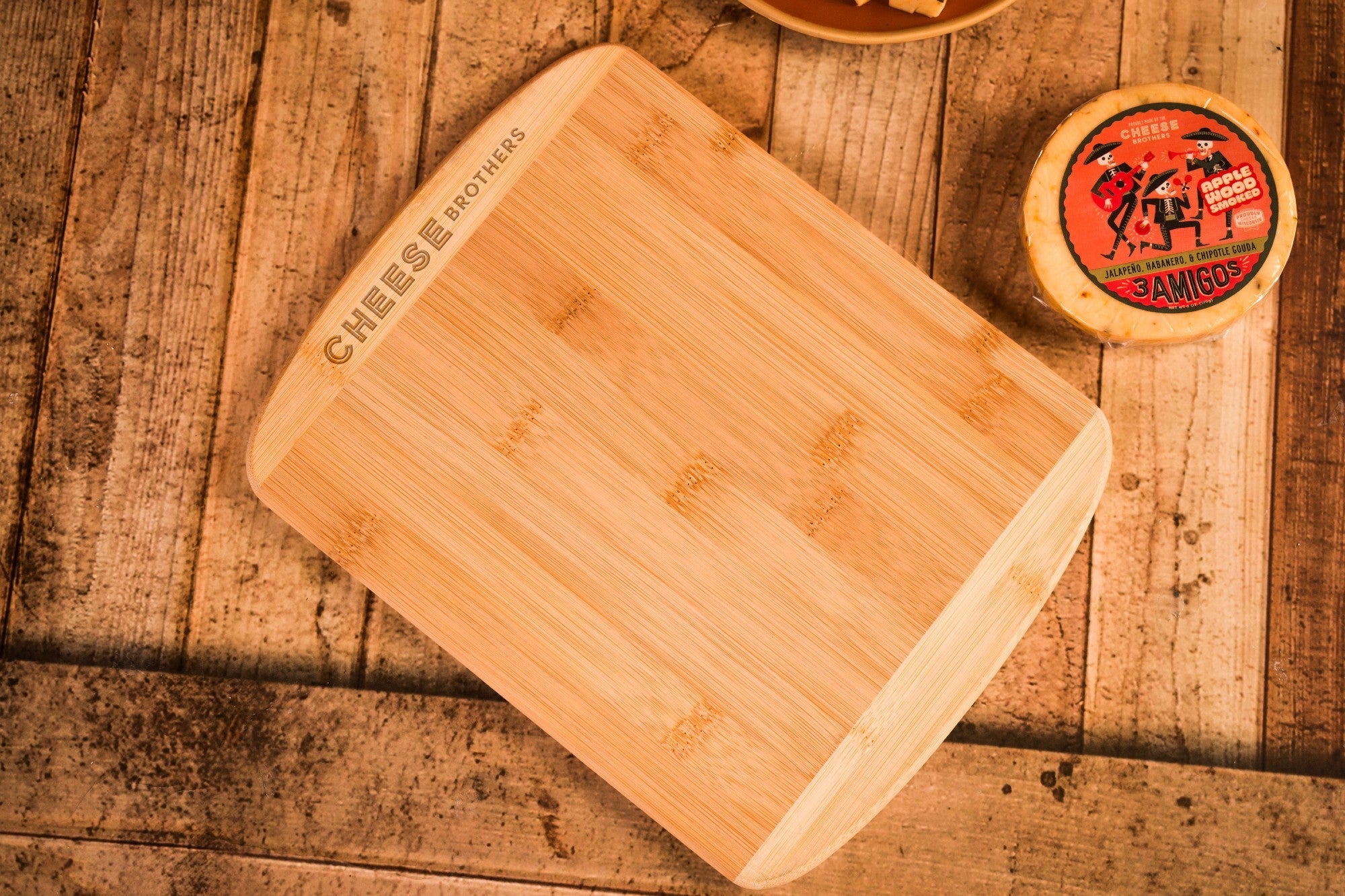 Cheese Brothers Inc. Just About Everything gift box with an 11-inch cutting board and assorted cheese and snack items.