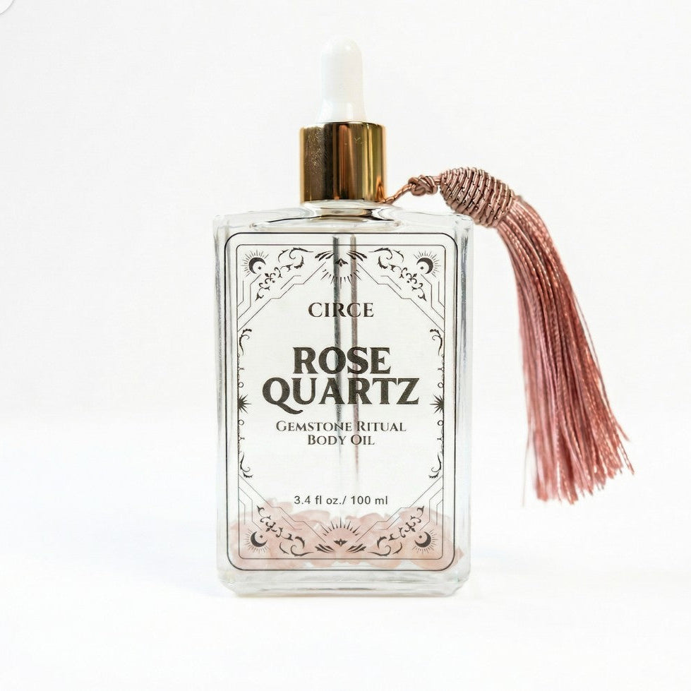 Rose Quartz Body Oil by Circe Boutique, 3.4 oz bottle with rose quartz crystal, promoting self-love and glowing skin.