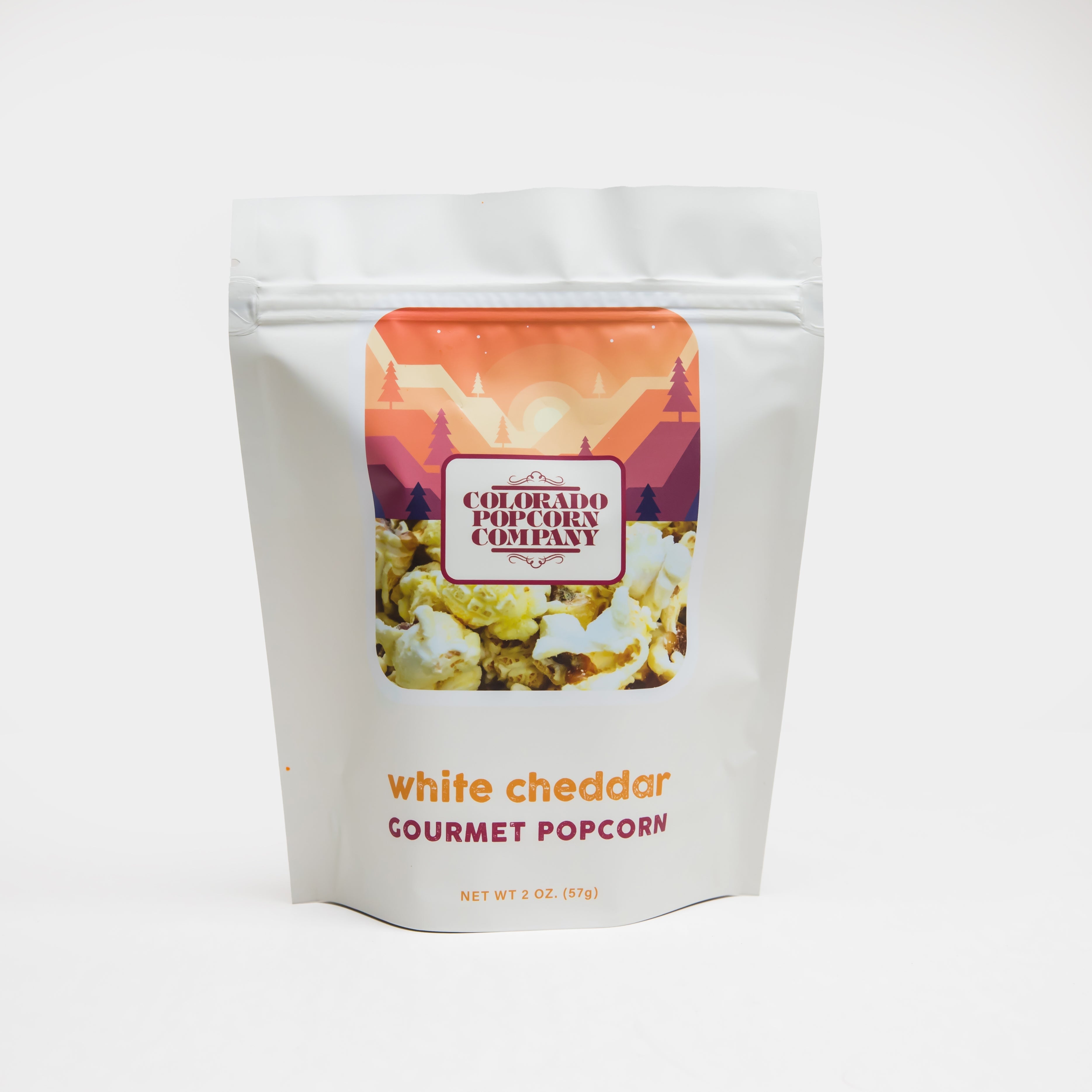 White Cheddar Popcorn from Colorado Popcorn Company in a 2 oz bag, showing crispy popcorn coated with white cheddar cheese.