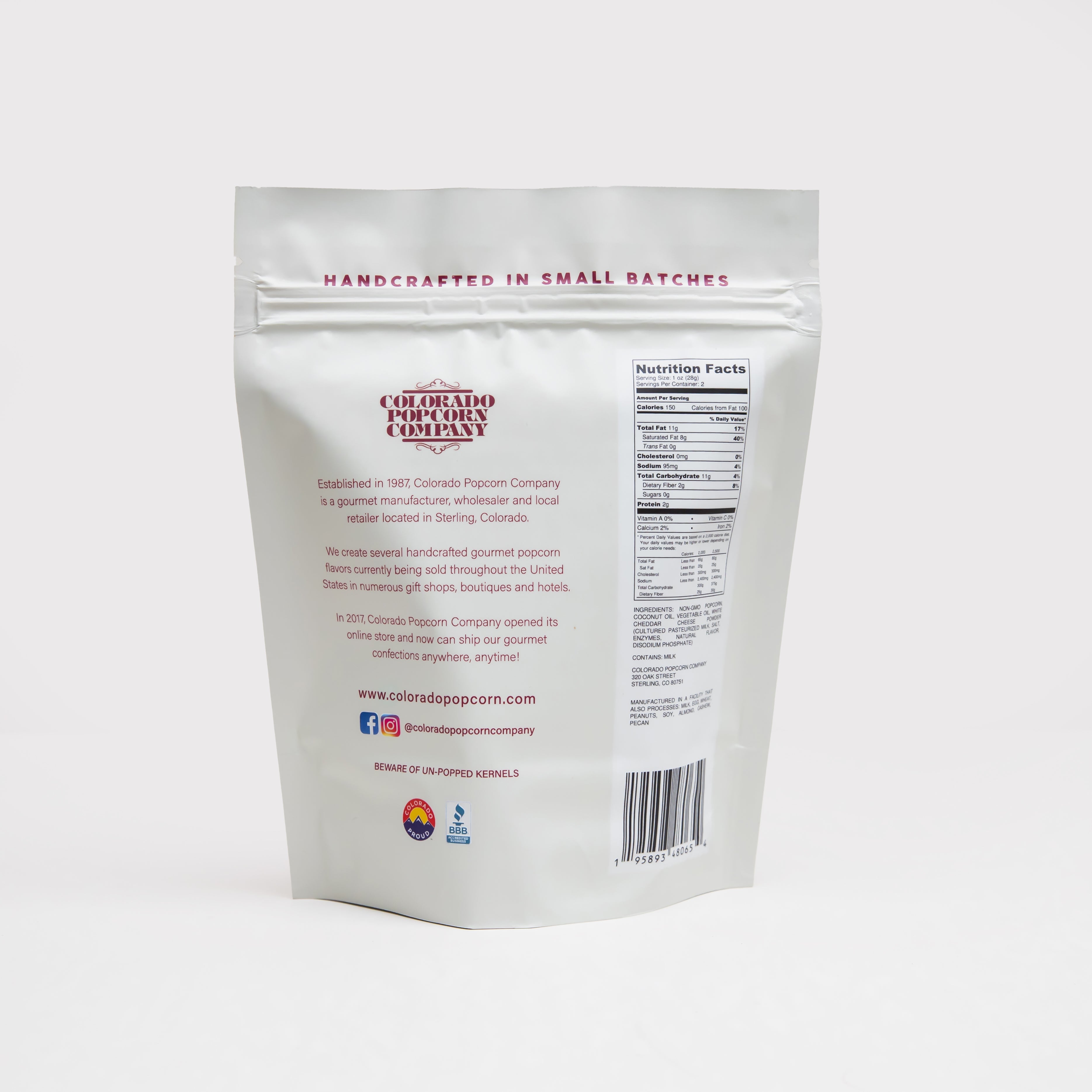 White cheddar popcorn in a bag from Colorado Popcorn Company, showcasing crispy, cheesy snack pieces in a 2 oz package.