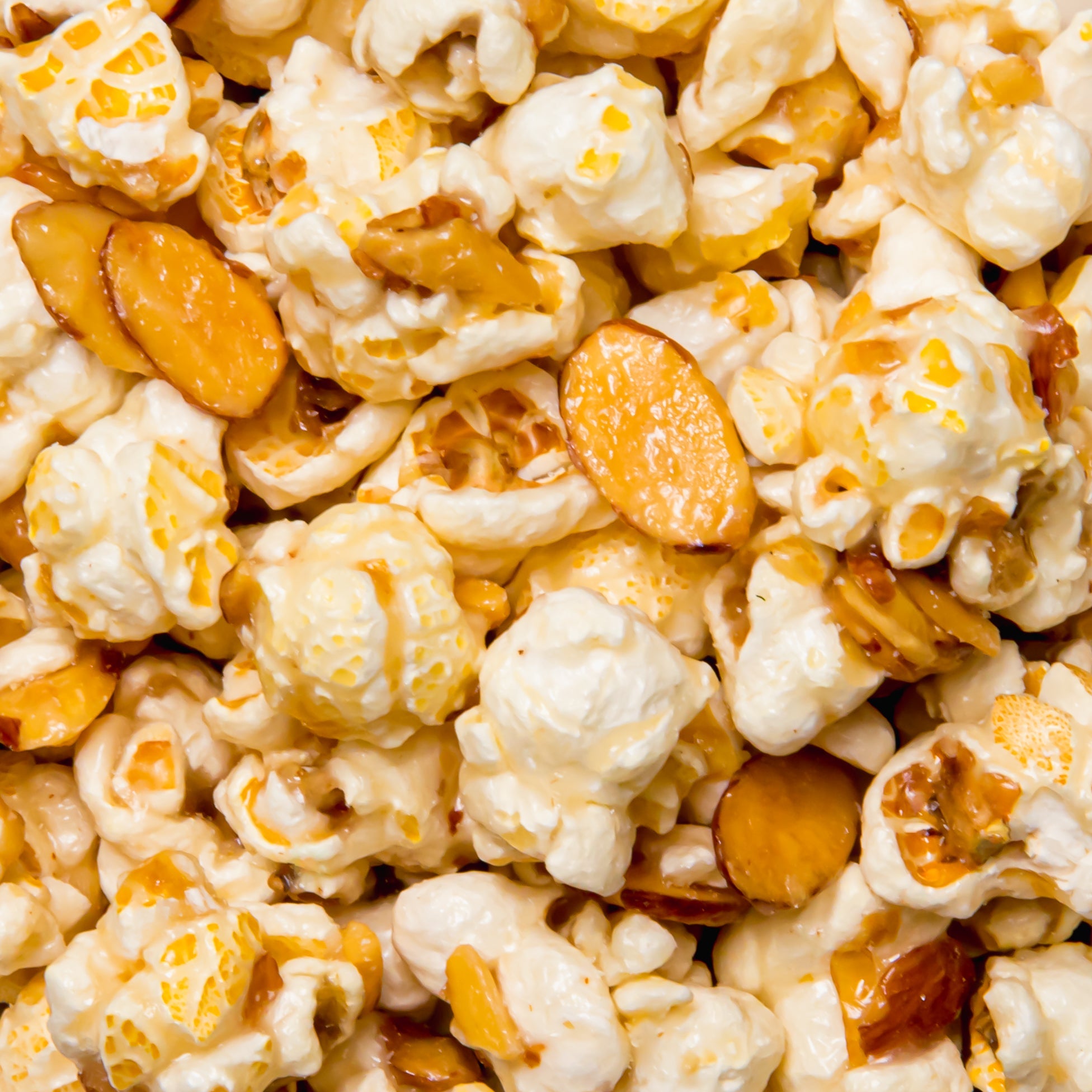 Amaretto flavored popcorn from Colorado Popcorn Company in a 5 oz bag, showing caramel-coated popcorn with a glossy finish.