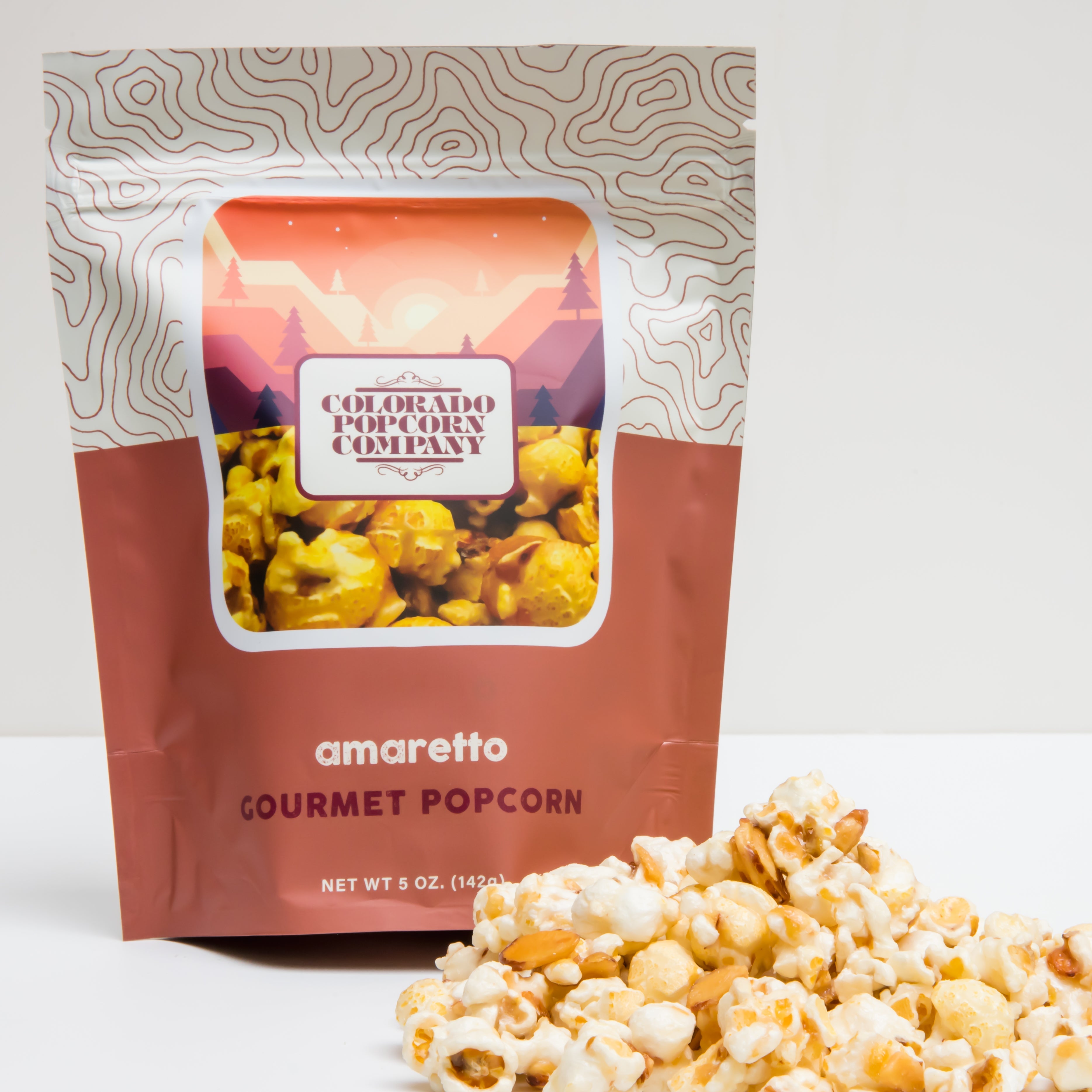 Amaretto flavored popcorn in a 5 oz bag from Colorado Popcorn Company, showcasing golden popcorn coated with almond-flavored glaze.