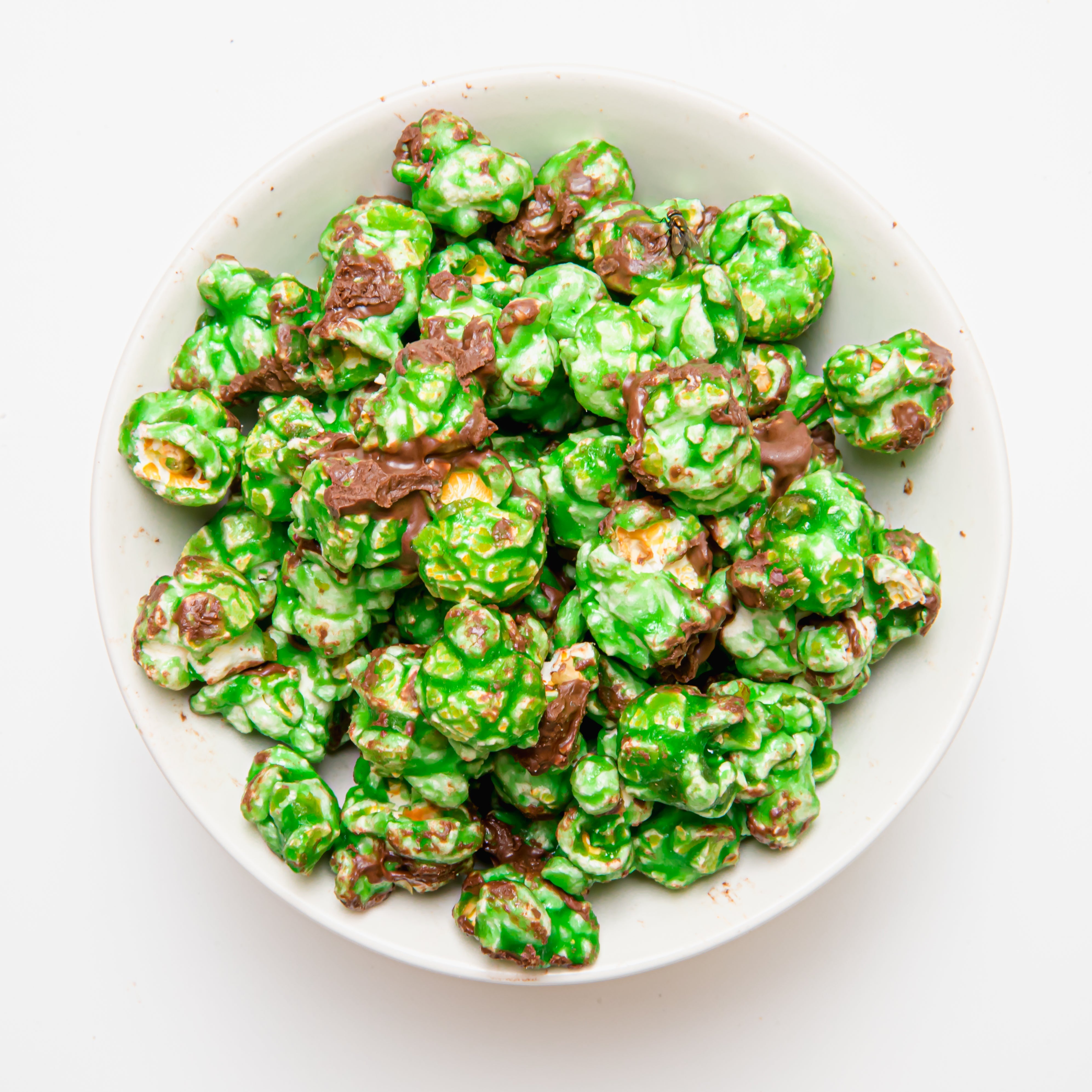 Chocolate mint popcorn in a bag by Colorado Popcorn Company, showing glossy chocolate coating and mint flavor details.