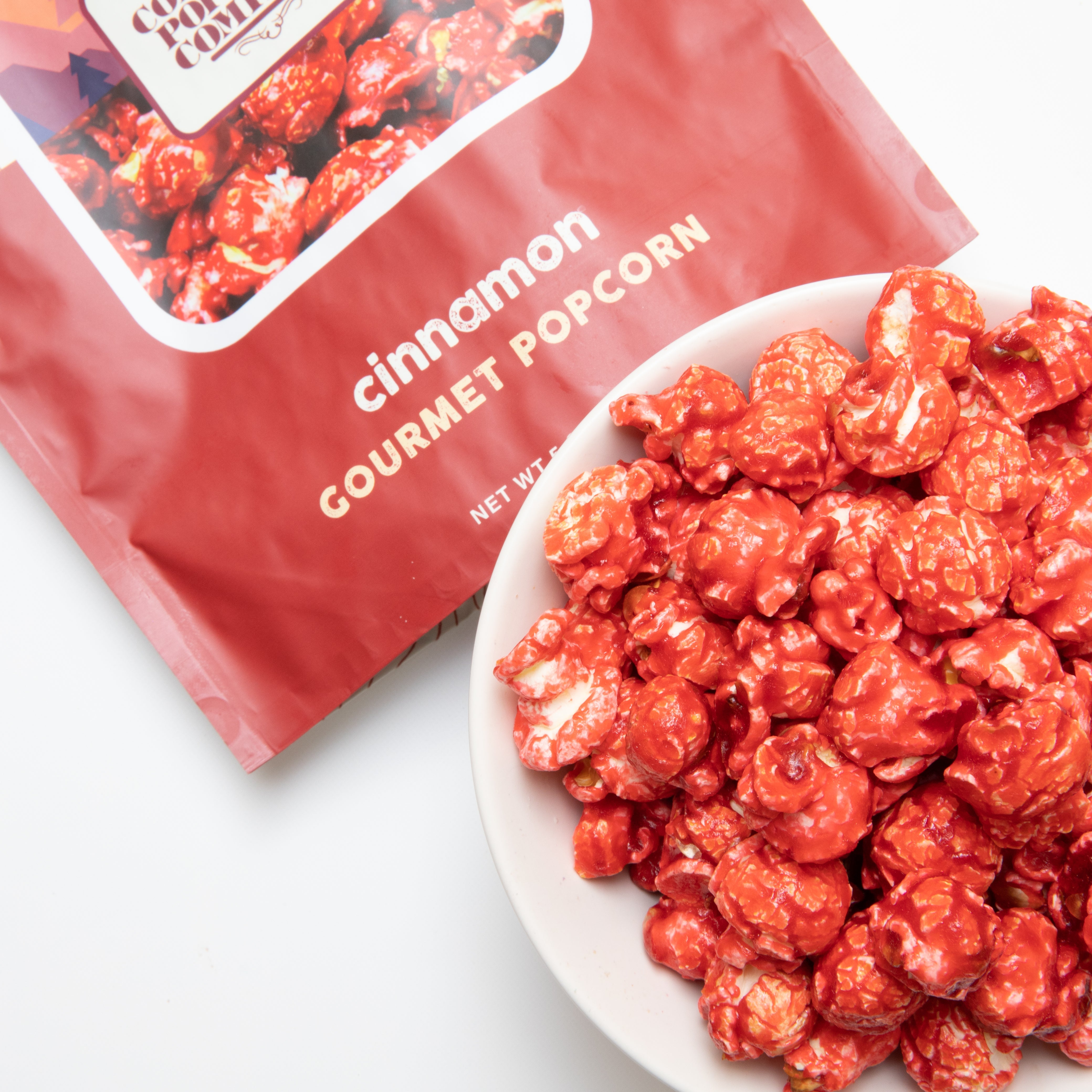Cinnamon popcorn from Colorado Popcorn Company in a 5 oz bag, featuring caramel-colored popcorn coated with cinnamon flavor.