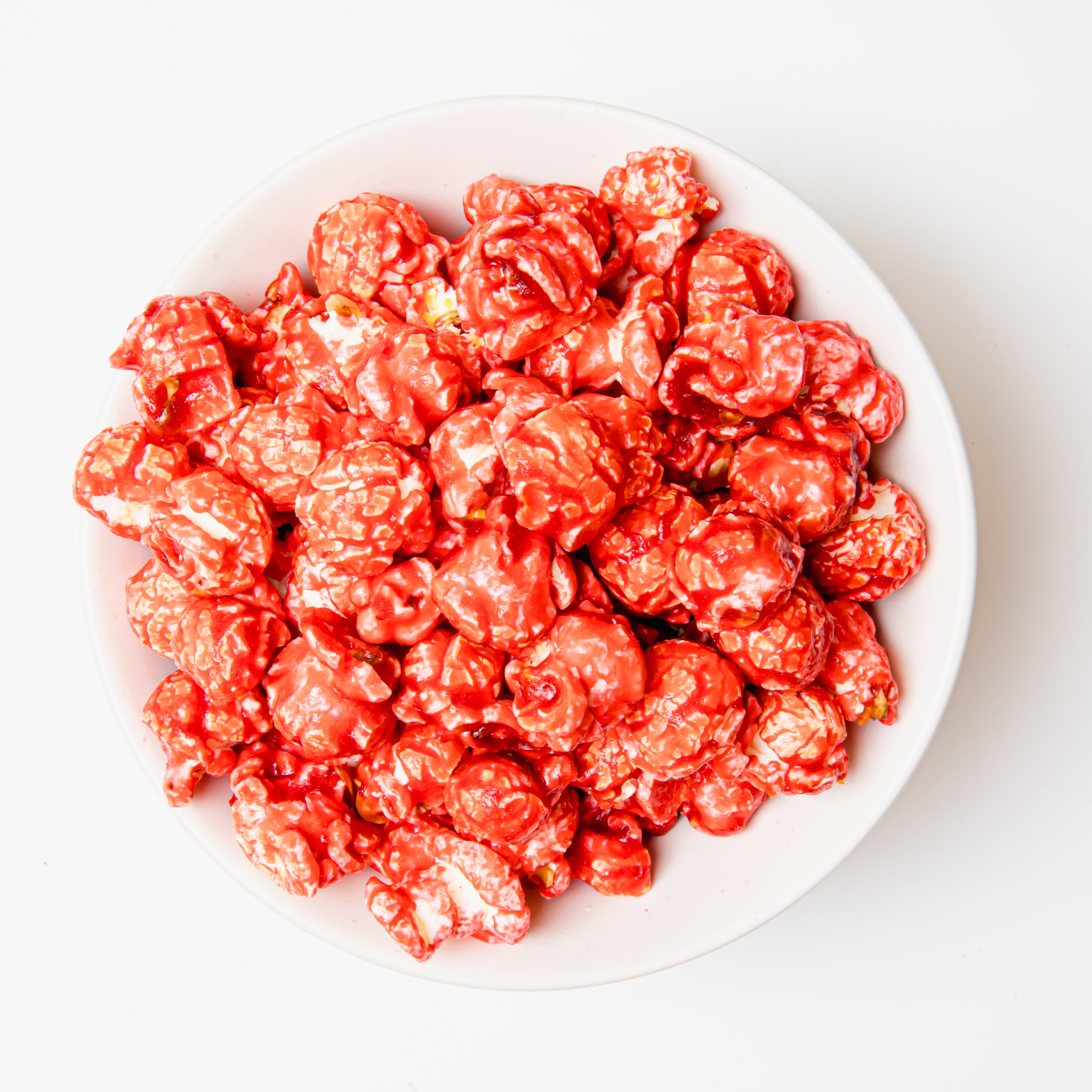 Cinnamon popcorn in a clear bag from Colorado Popcorn Company, 5 oz net weight with cinnamon-flavored coated popcorn.