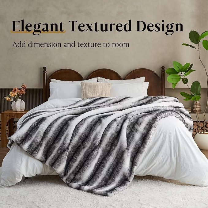 Black and white luxury faux fur blanket from CozyNest Decor, soft plush throw for couch, bed, or sofa, reversible and thick.
