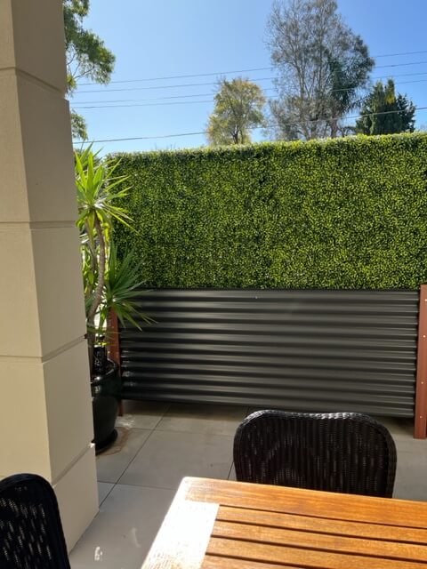 Dark green artificial boxwood hedge with planter, UV resistant, 30x30 inches, ideal for privacy and commercial landscaping.