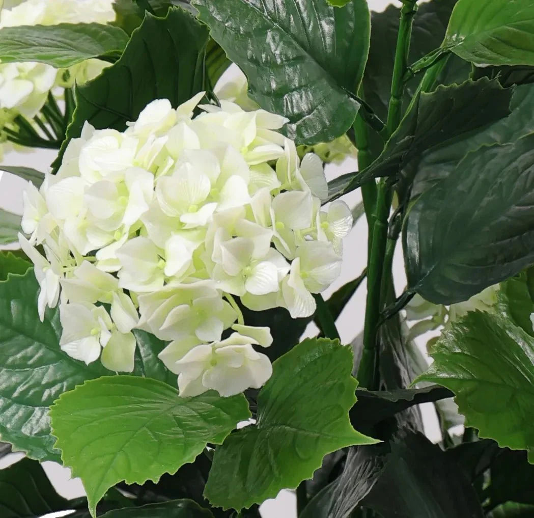 Close-up of a white hydrangea artificial tree with lush blooms, UV resistant, designed by Designer Plants USA.