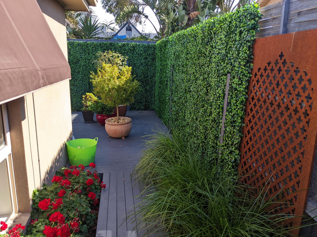 Artificial jasmine green wall panel by Designer Plants USA, 40x40 inch vertical garden with UV-resistant, commercial-grade living wall design.