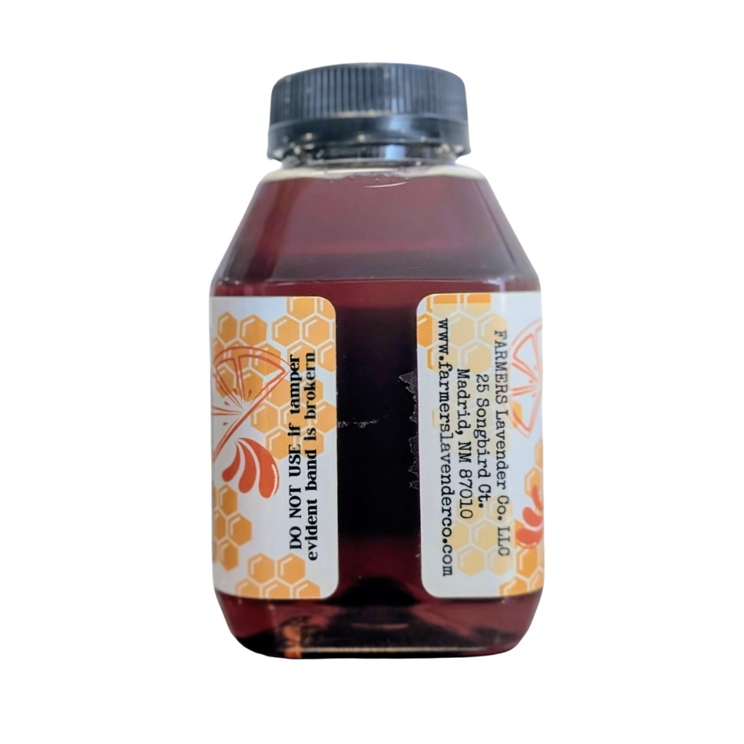 Jar of orange-infused honey from FARMERS Lavender Co., showcasing smooth honey with orange infusion and natural golden color.