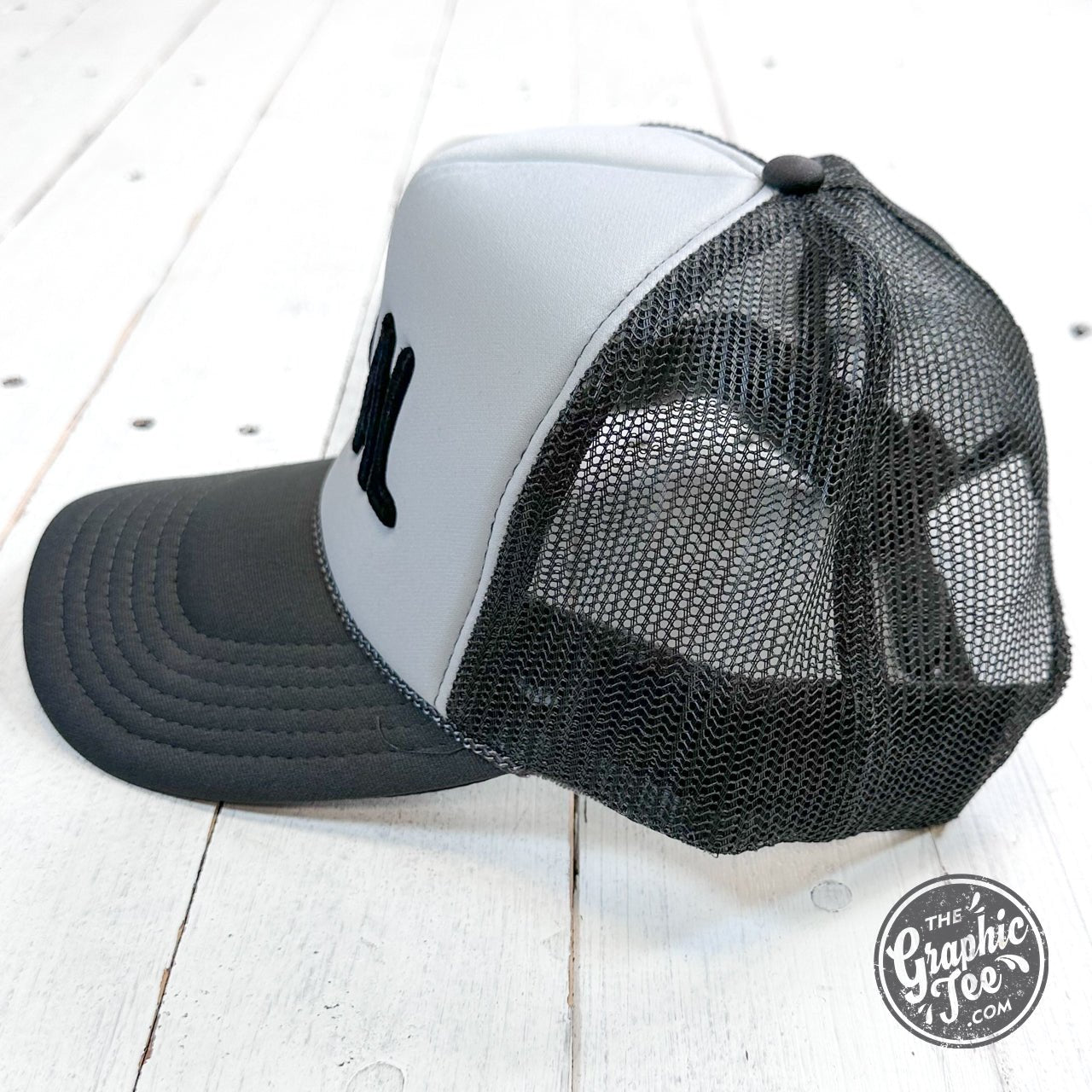 Feral embroidered trucker cap featuring detailed feral animal design on front, adjustable snapback, and mesh back for ventilation.