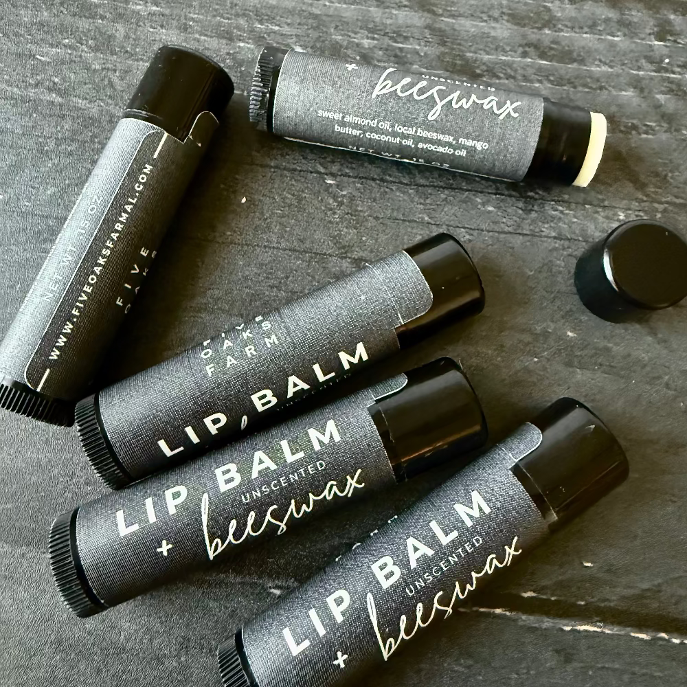 Unboxed Five Oaks Farm beeswax unscented lip balm showing the small jar with natural beeswax texture and label.