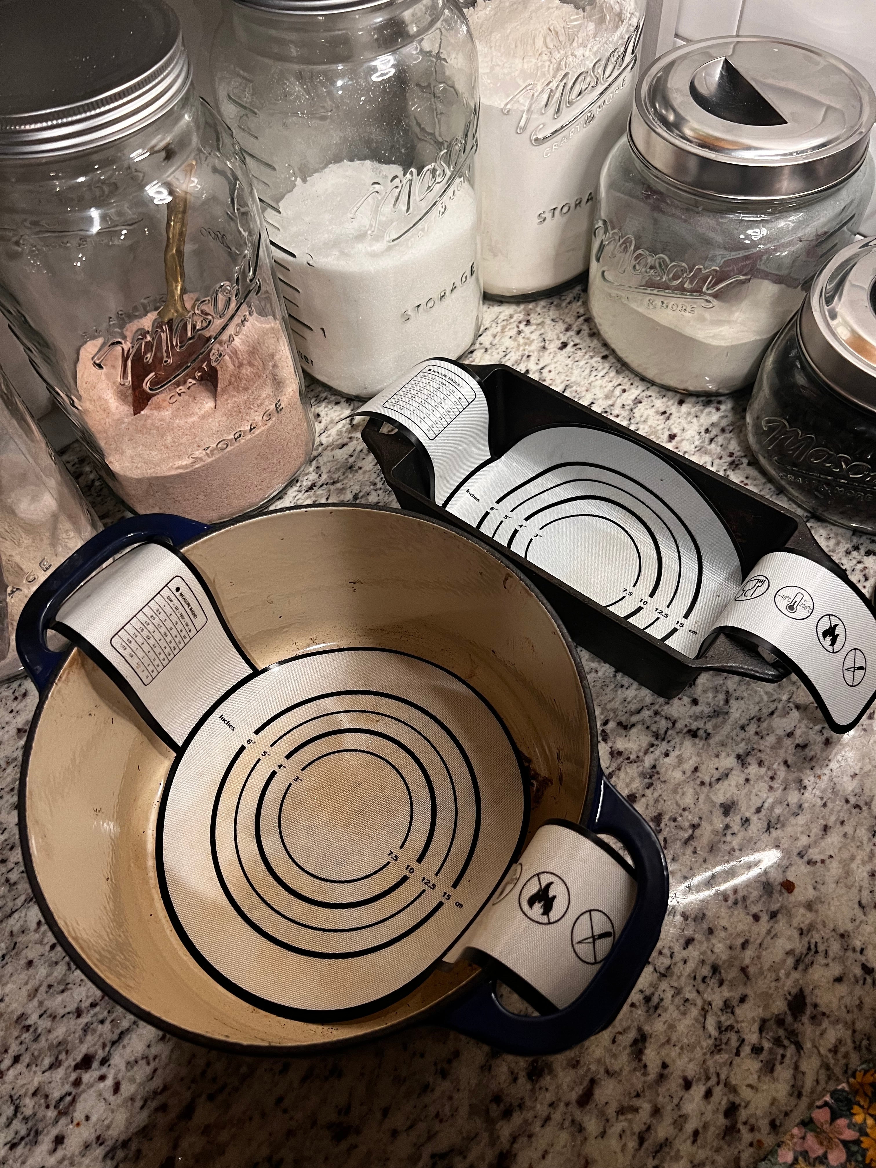 Five Oaks Farm Dough Sling used for baking, featuring a durable fabric strap and wooden handles for easy dough handling.