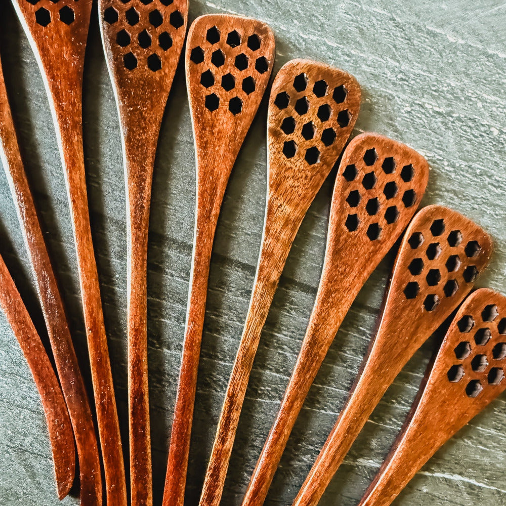 Honey spoon from Five Oaks Farm, natural wooden utensil with a rounded tip, used for serving honey from the farm.