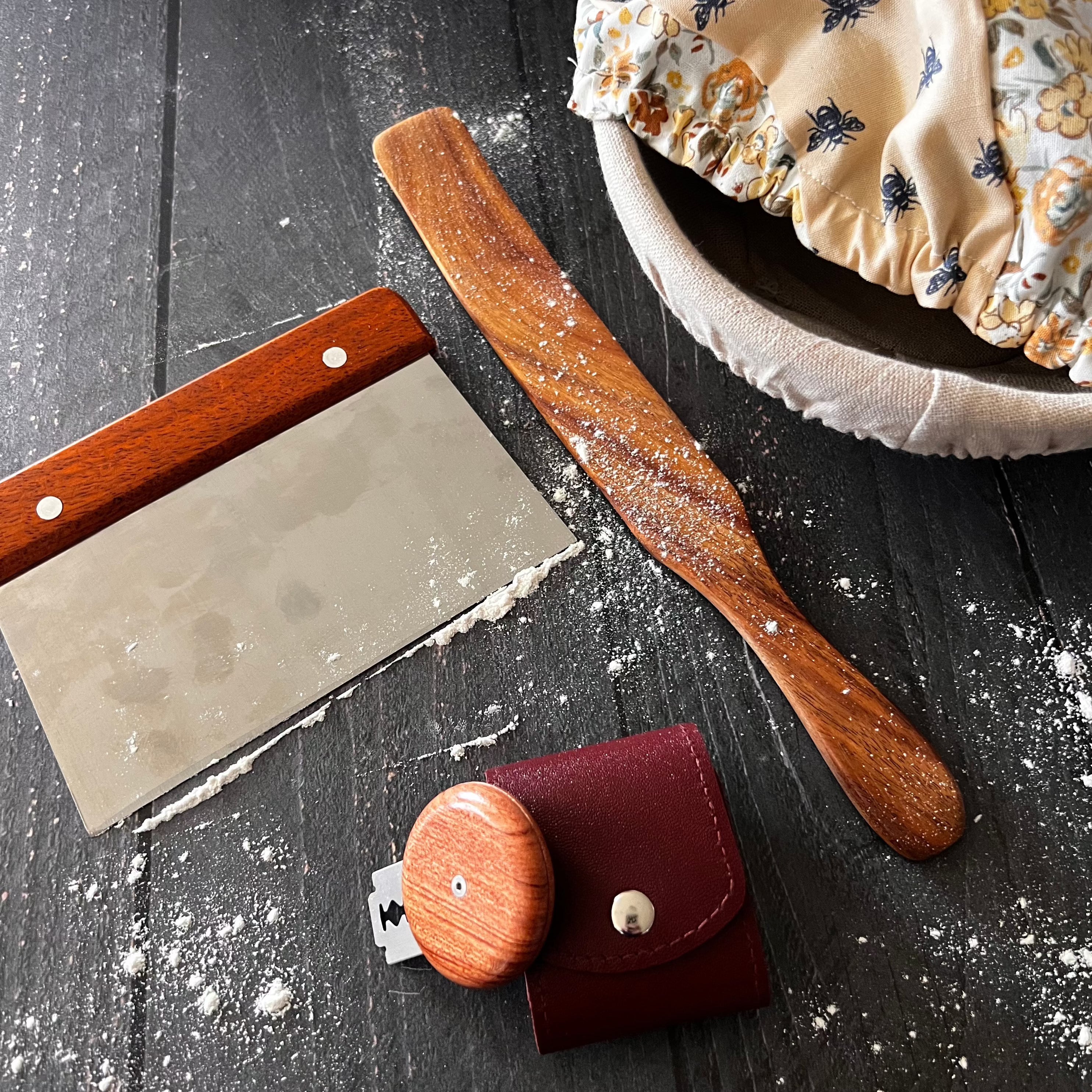 Handcrafted wooden Spurtle from Five Oaks Farm, shown on rustic background, ideal for stirring and serving traditional Scottish dishes.